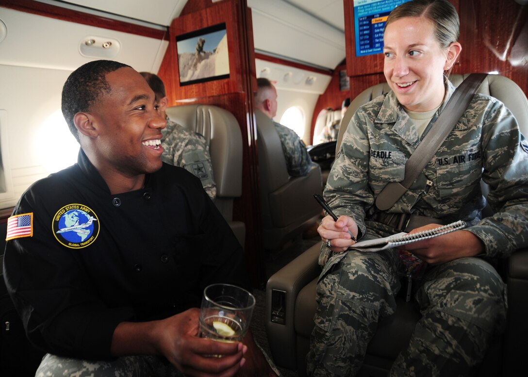 Airman 1st Class Lindsey Beadle, 11th Wing Public Affairs journalist interviews Sergeant Byron Watson, U.S. Army Priority Air Transport Command, flight steward, during a flight from Joint Base Andrews Md., June 21.  The flight was a USAPAT training mission for flight stewards, flight engineers, and flight communications support elements for new members of the unit.  (U.S. Air Force photo/Staff Sgt Nichelle Anderson)