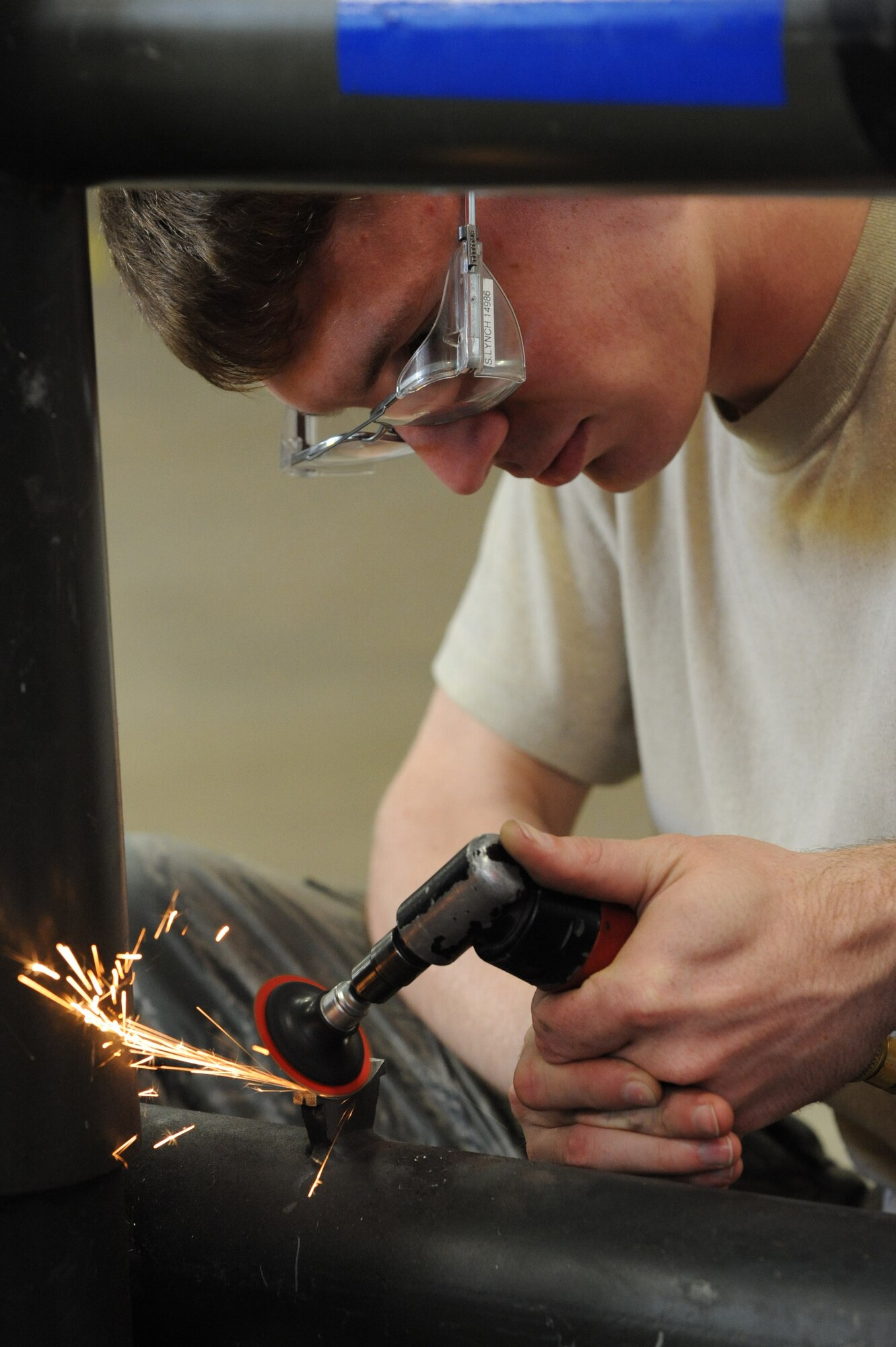 Staff Sgt. Steven Lynch, 2nd Maintenance Squadron, grinds a hydraulic pump mount in the 2nd Maintenance Squadron Fabrication Flight building on Barksdale Air Force Base, La., June 22. The pump mount holds the hydraulic pump for a wheel dolly used to change and transport tires for aircraft. (U.S. Air Force photo/ Airman 1st Class Micaiah Anthony)(RELEASED)