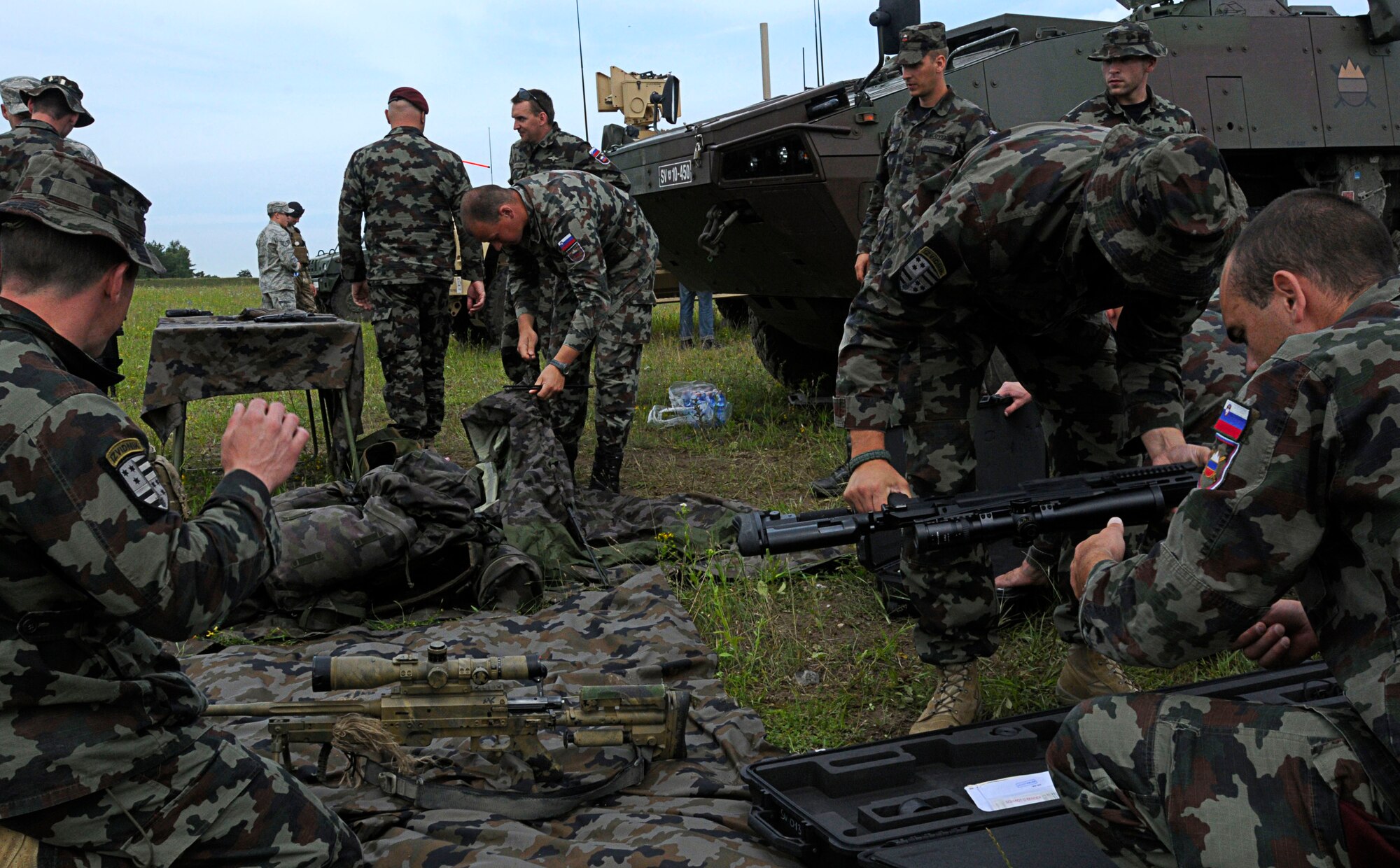 Slovenian army personnel break down their static display after the opening ceremony for Allied Strike 2011, Grafenwoher Training Area, Germany, June 22, 2011. Allied Strike is Europe's premier Close Air Support exercise, held annually to conduct robust, realistic CAS training that helps build partnership capacity among Allied NATO nations and refine the latest operational CAS tactics. (U.S. Air Force photo by Airman 1st Class Desiree W. Esposito)