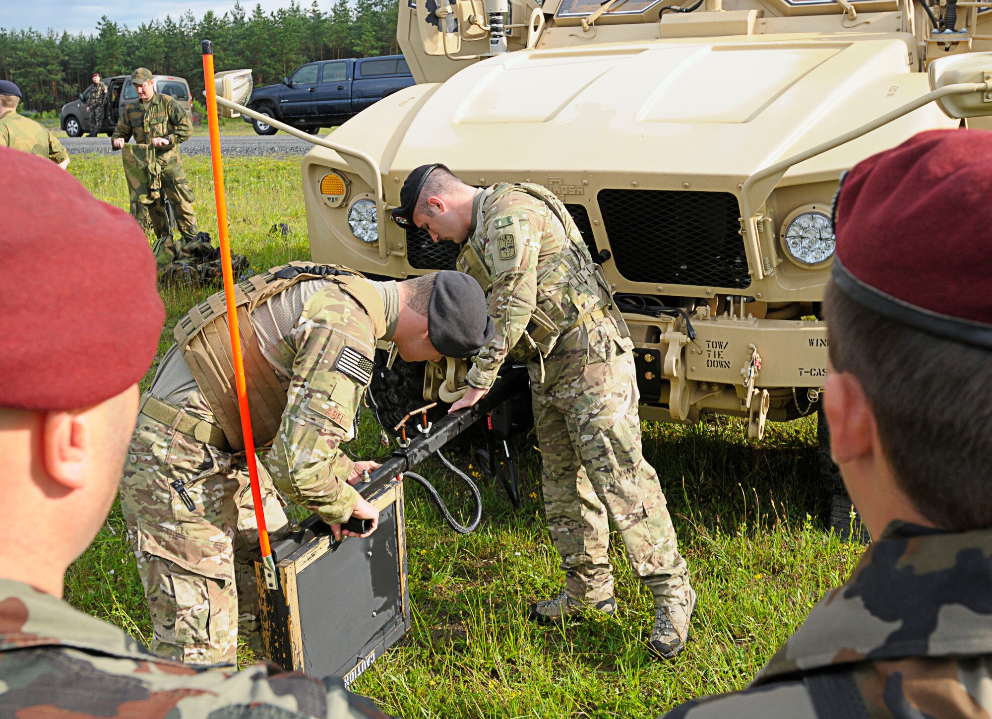 U.S. Air Force Airman 1st Class Anthony Abel and Airman 1st Class Anthony Puccaroni, ROMADs with the 2nd Air Support Operations Squadron, demonstrates an Improvised Explosive Device countermeasure called a "Rhino" to Slovenian army personnel during the opening ceremony for Allied Strike 2011, Grafenwoher Training Area, Germany, June 22, 2011. A ROMAD, or "Radio Operator, Maintainer and Driver," is a JTAC in training. Allied Strike is Europe's premier Close Air Support exercise, held annually to conduct robust, realistic CAS training that helps build partnership capacity among Allied NATO nations and refine the latest operational CAS tactics. (U.S. Air Force photo by Airman 1st Class Desiree W. Esposito)
