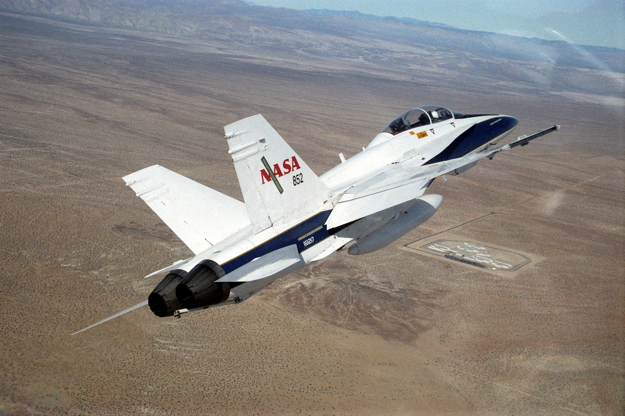 A NASA F-18 banks left in flight over the desert. The NASA-Dryden Flight Research Center will use its fleet of F-18 aircraft to carry out a study that will commence this fall to gather data from base residents on their attitudes towards aircraft noise, specifically sonic booms. (Courtesy photo)