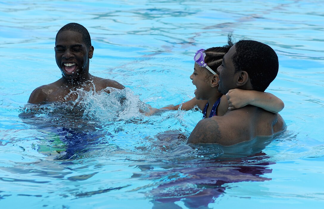 Devin Cobb, 13, Deona Williams, 7, and Devonte Williams, children of Ramona Williams, play in the Shellbank outdoor pool at Langley Air Force Base, Va., June 19, 2011. The 633d Force Support Squadron pools provide year-long swimming passes, swimming lessons, swim teams and the ability to have pool parties. (U.S. Air Force photo by Airman 1st Class Teresa Cleveland/Released)

