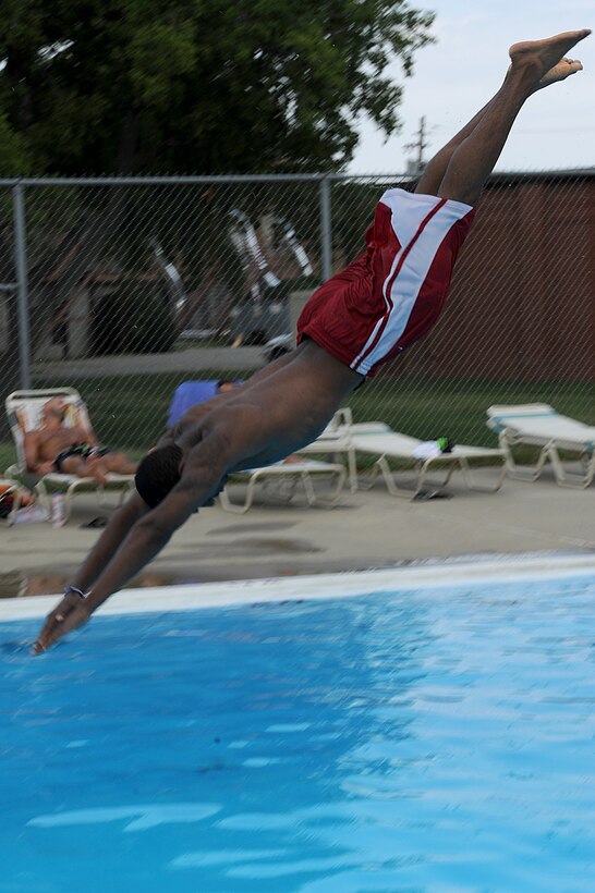 Devonte Williams, son of Ramona Williams, jumps from the diving board at the Shellbank outdoor pool at Langley Air Force Base, Va., June 19, 2011. The 633d Force Support Squadron operates four swimming pools, which include the Shellbank indoor and outdoor, Bethel Manor and the Langley Club pools. (U.S. Air Force photo by Airman 1st Class Teresa Cleveland/Released) 