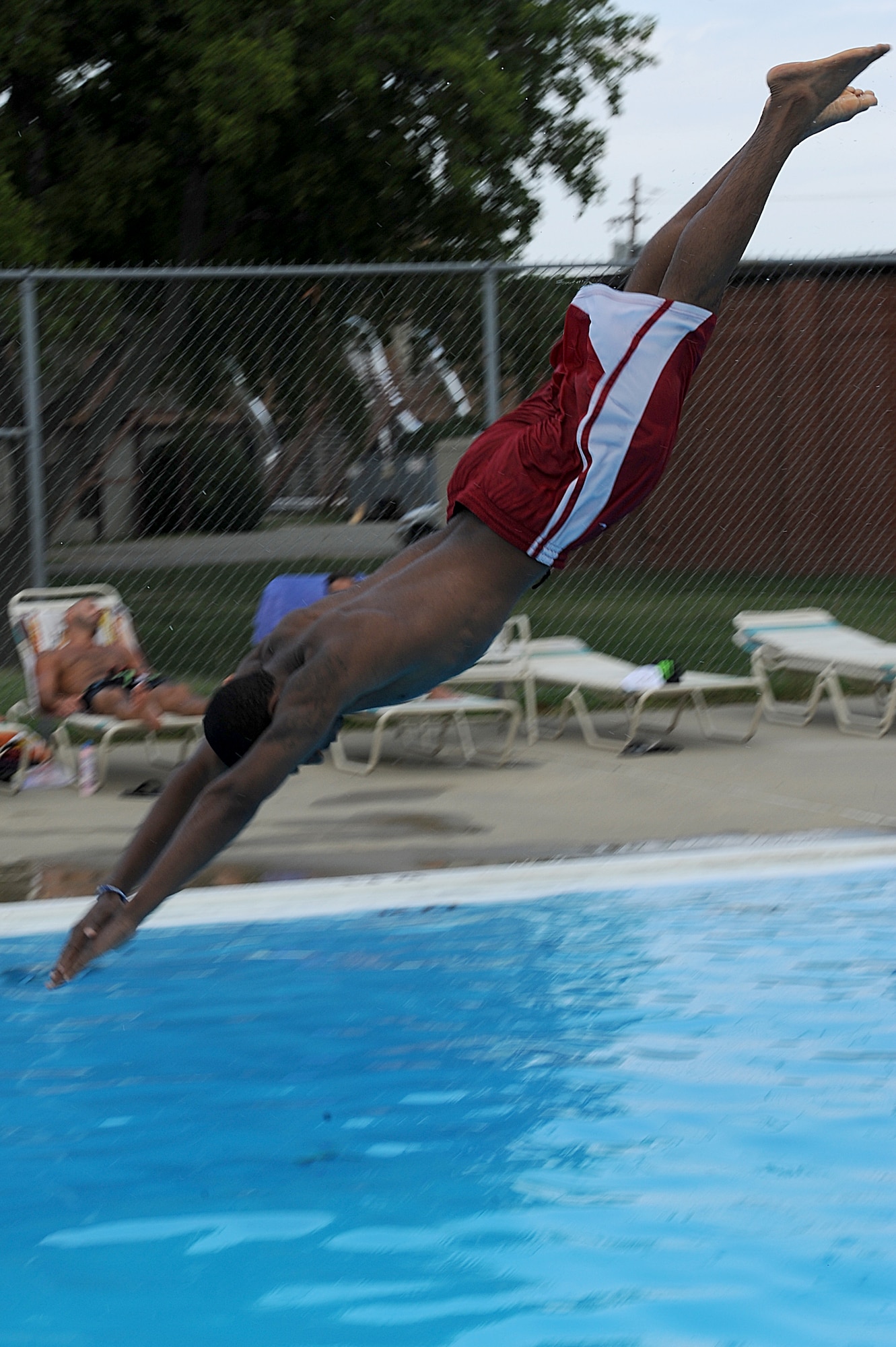 Devonte Williams, son of Ramona Williams, jumps from the diving board at the Shellbank outdoor pool at Langley Air Force Base, Va., June 19, 2011. The 633d Force Support Squadron operates four swimming pools, which include the Shellbank indoor and outdoor, Bethel Manor and the Langley Club pools. (U.S. Air Force photo by Airman 1st Class Teresa Cleveland/Released) 