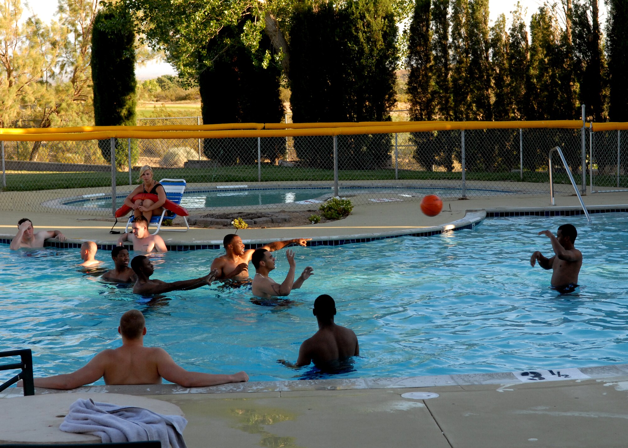 In an effort to stay cool, Edwards servicemembers enjoy the pool at Club Muroc during the American Red Cross Airmen and Marine Appreciation Dinner June 14. The dinner was held to give Airmen and Marines a chance to mingle and spend an evening out of the dormitories. (Air Force photo by Veronica Buening)