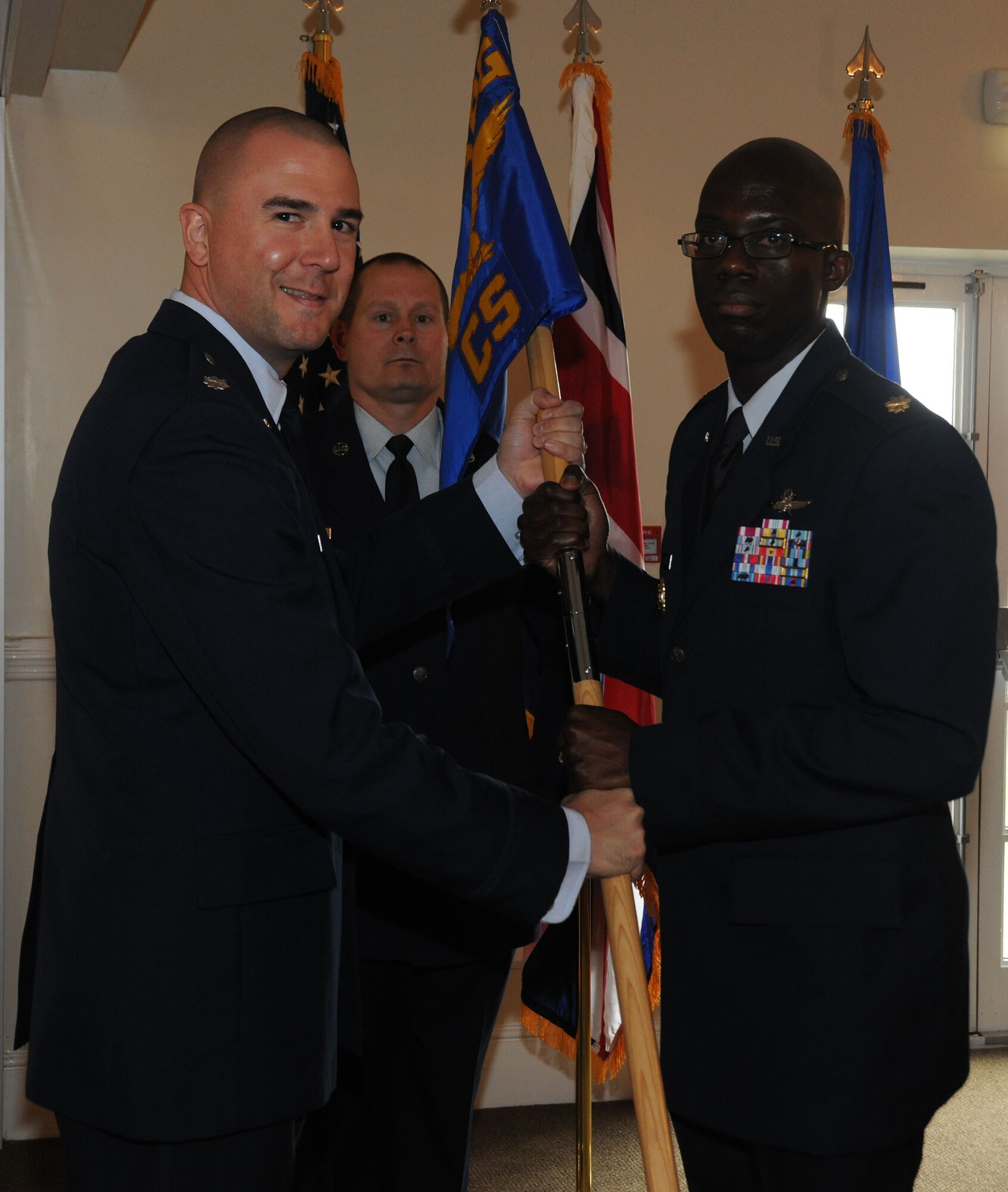 Lt. Col. Michael Reiner presents the 423rd Communications Squadron guidon to Maj. Carlos Alford during a change of command ceremony June 22. Colonel Reiner is the 423rd Air Base Group commander and Maj. Alford is the new 423rd CS commander.