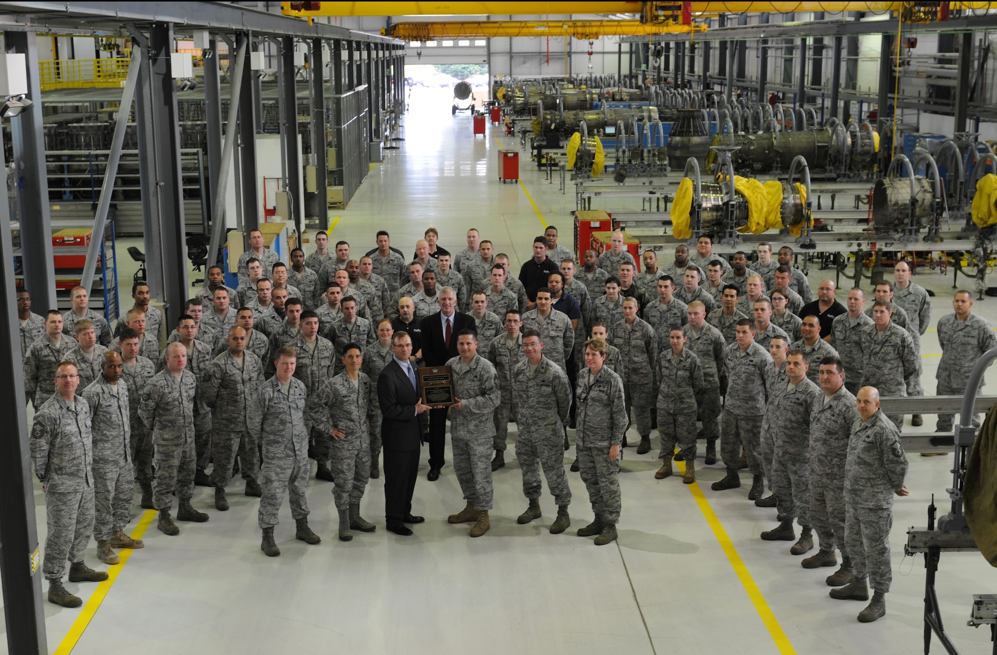ROYAL AIR FORCE LAKENHEATH, England -- Airmen from the 48th Component Maintenance Squadron Propulsion flight receive the Golden Wrench Award from the Pratt & Whitney aircraft engine company at Building 1225 on June 21, 2011. The flight received the award due to the Airmen's effort in streamlining production of spare engines during the past 18 months.  (U.S. Air Force photo/Airman Cory Payne)