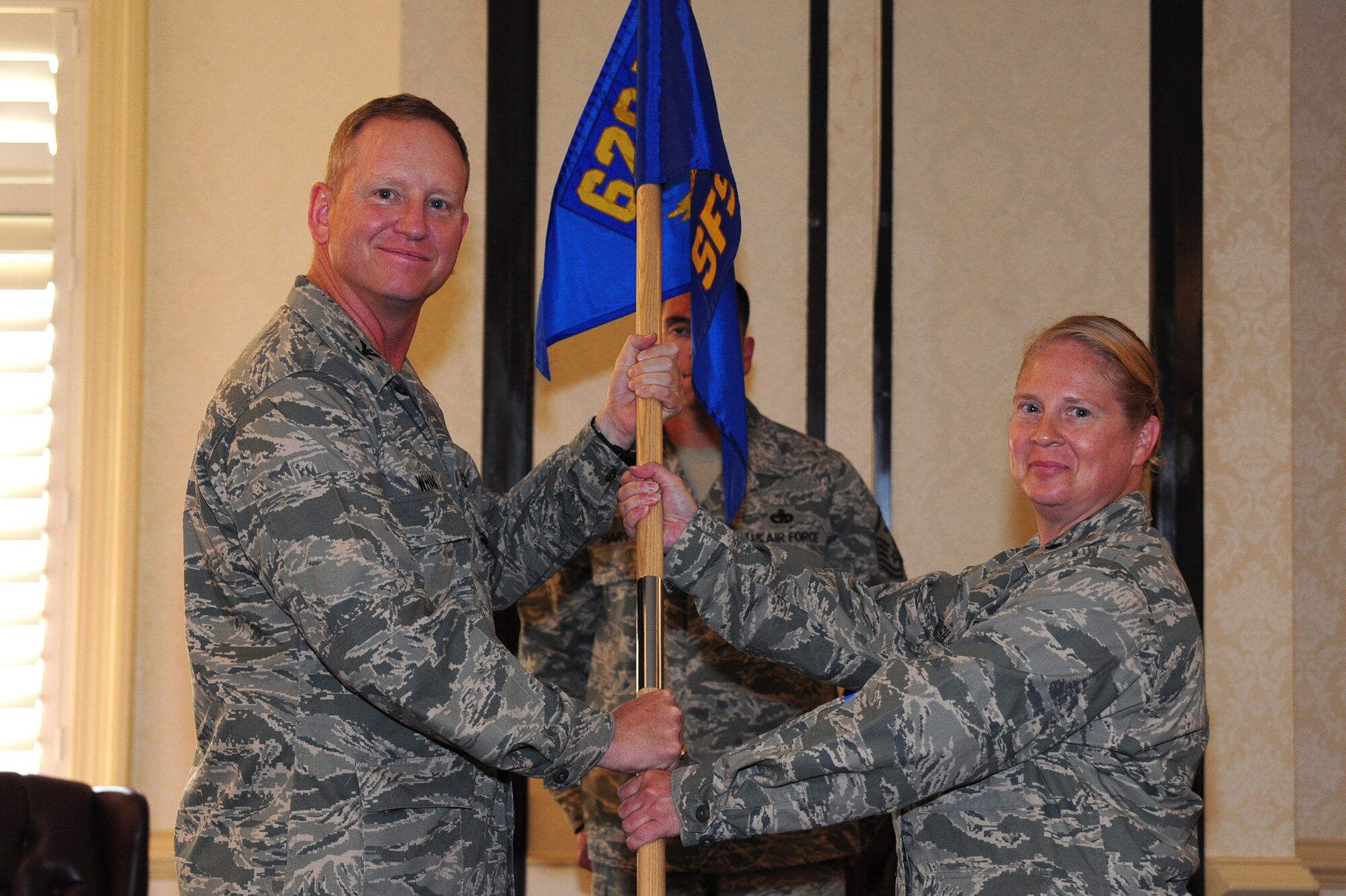 Lt. Col. Frances Dorish accepts the 628th Security Forces Squadron guidon from Col. Benjamin Wham at the 628 SFS Change of Command June 22 at Joint Base Charleston. Colonel Dorish is the new 628 SFS commander and Colonel Wham is the 628 Mission Support Group commander. (U.S. Air Force photo/ Tech. Sgt. Chrissy Best)
