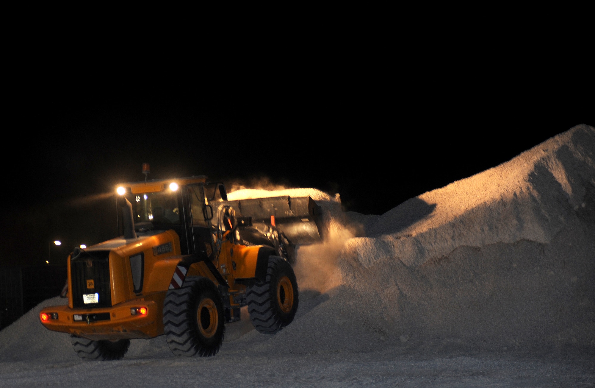 The 379th Expeditionary Civil Engineer Squadron "Dirt Boys" spread dirt in 3-5 inch lifts, wet it down and roll it with the steel wheel roller to compact the material for a project to extend a storage area at an air base in Southwest Asia, June 16. (U.S. Air Force photo/Staff Sgt. Liliana Moreno)           