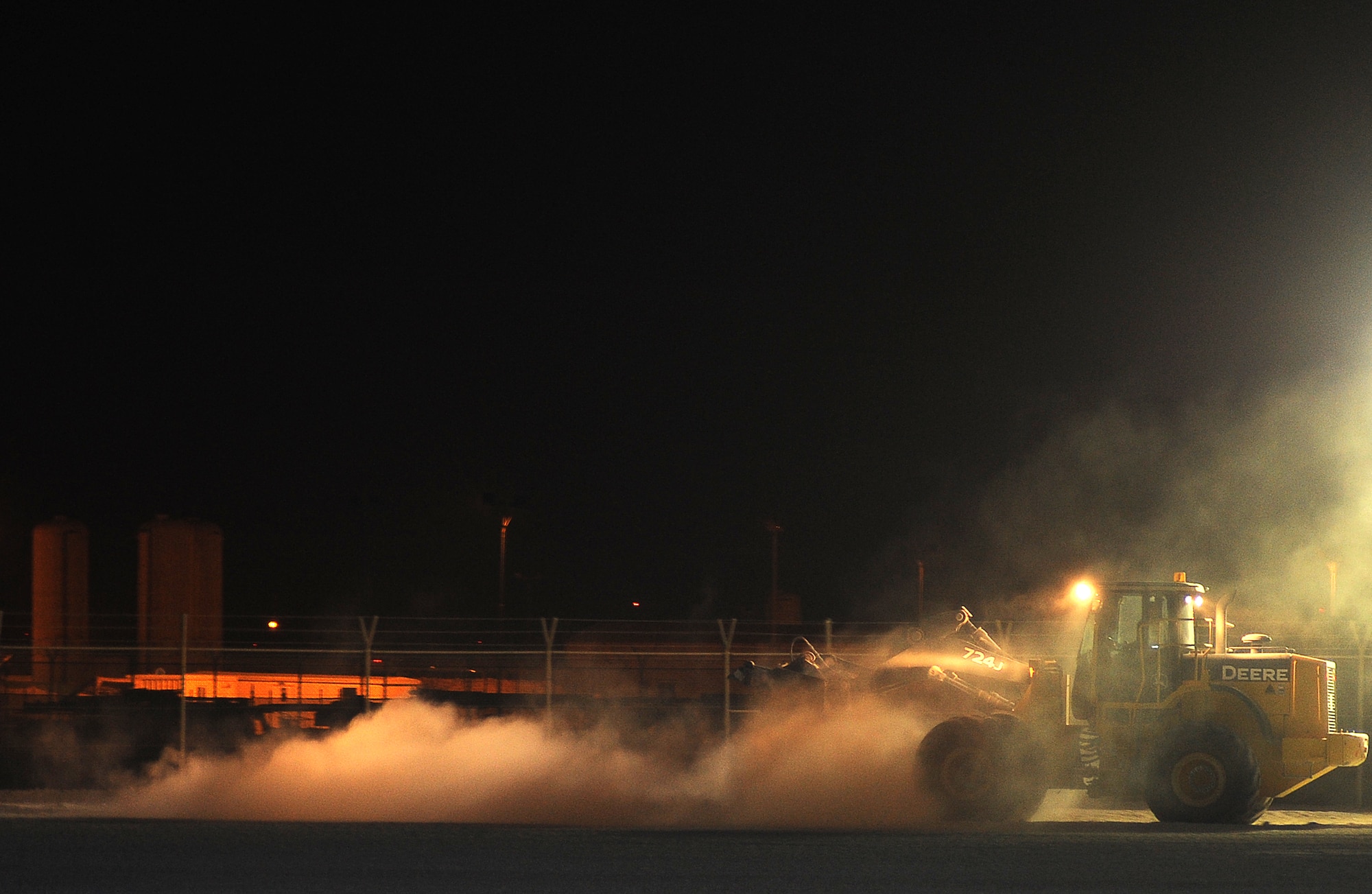 The 379th Expeditionary Civil Engineer Squadron "Dirt Boys" spread dirt in 3-5 inch lifts, wet it down and roll it with the steel wheel roller to compact the material for a project to extend a storage area at an air base in Southwest Asia, June 16. (U.S. Air Force photo/Staff Sgt. Liliana Moreno)                               