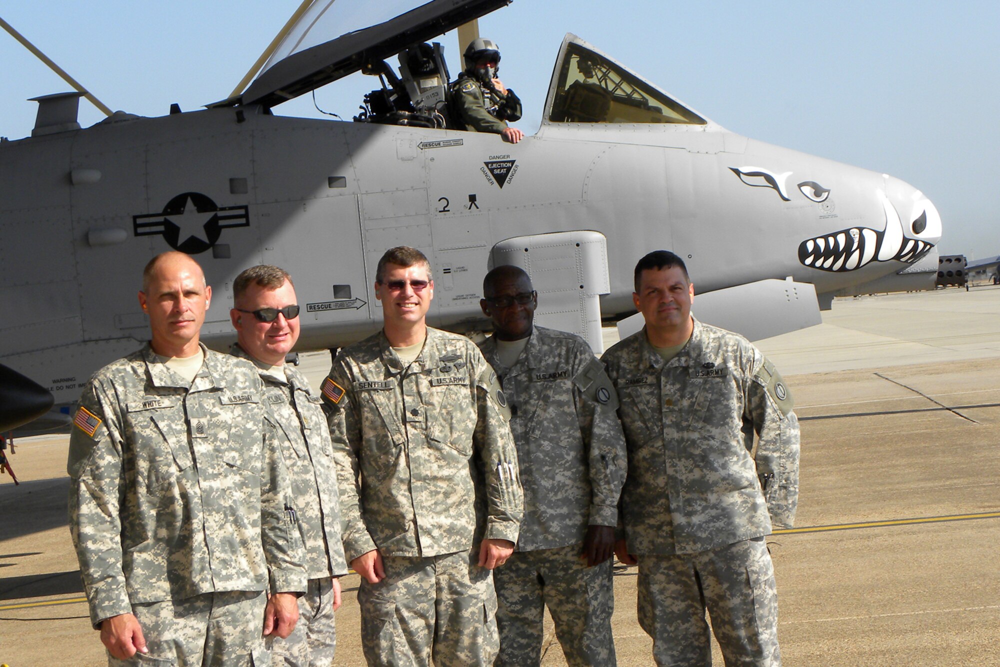 Lt. Col. James Macaulay, deputy commander, 917th Fighter Group, stands by in the cockpit of an A-10 Thunderbolt II, as a group of U.S. Army visitors pose for a photo at Barksdale Air Force Base, La., June 16, 2011. The group visited Barksdale to get a close up look at the type of jet that provided “dedicated air support” to their unit members in the field in Iraq and Afghanistan. (L-R) Command Sergeant Major Randy White, Maj. Chris Franklin, executive officer, and Lt. Col. Sherb Sentell, battalion commander, of the 2203rd Mobilization Support Battalion, Command Sergeant Major, Everett Stanton, 2205rd Mobilization Support Battalion and Maj. David Ramirez, executive officer, 2204 Mobilization Support battalion. All three units are based in Bossier City, La. (U.S. Air Force photo/Betty Stephens)
