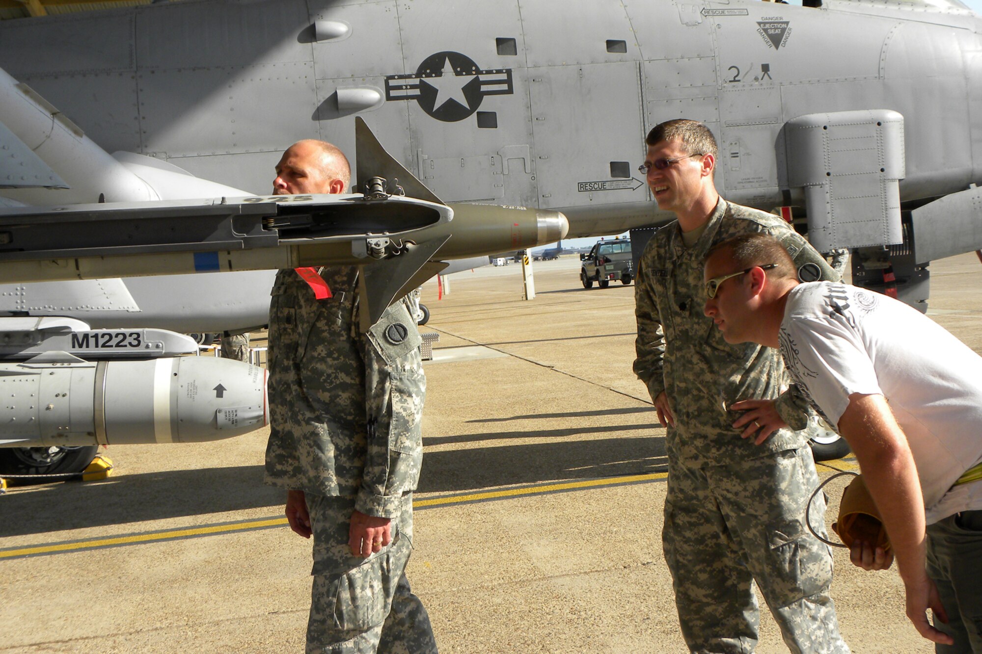 Joshua Huffman, an Air Reserve Technician with the 917th Aircraft Maintenance Squadron, explains the armament on an A-10 Thunderbolt II U.S. Army Command Sergeant Major Randy White, 2203rd Mobilization Support Battalion and Lt. Col. Sherb Sentell, battalion commander for the 2203rd MSB, at Barksdale Air Force Base, La., June 16, 2011.  A small group from the Army visited Barksdale to get a close up look at the type of jet that provides “dedicated air support” to their unit members in the field in Iraq and Afghanistan. Huffman is a Staff Sgt. in the Air Force Reserves assigned to the 917th AMXS as a crew chief. (U.S. Air Force photo/Betty Stephens)