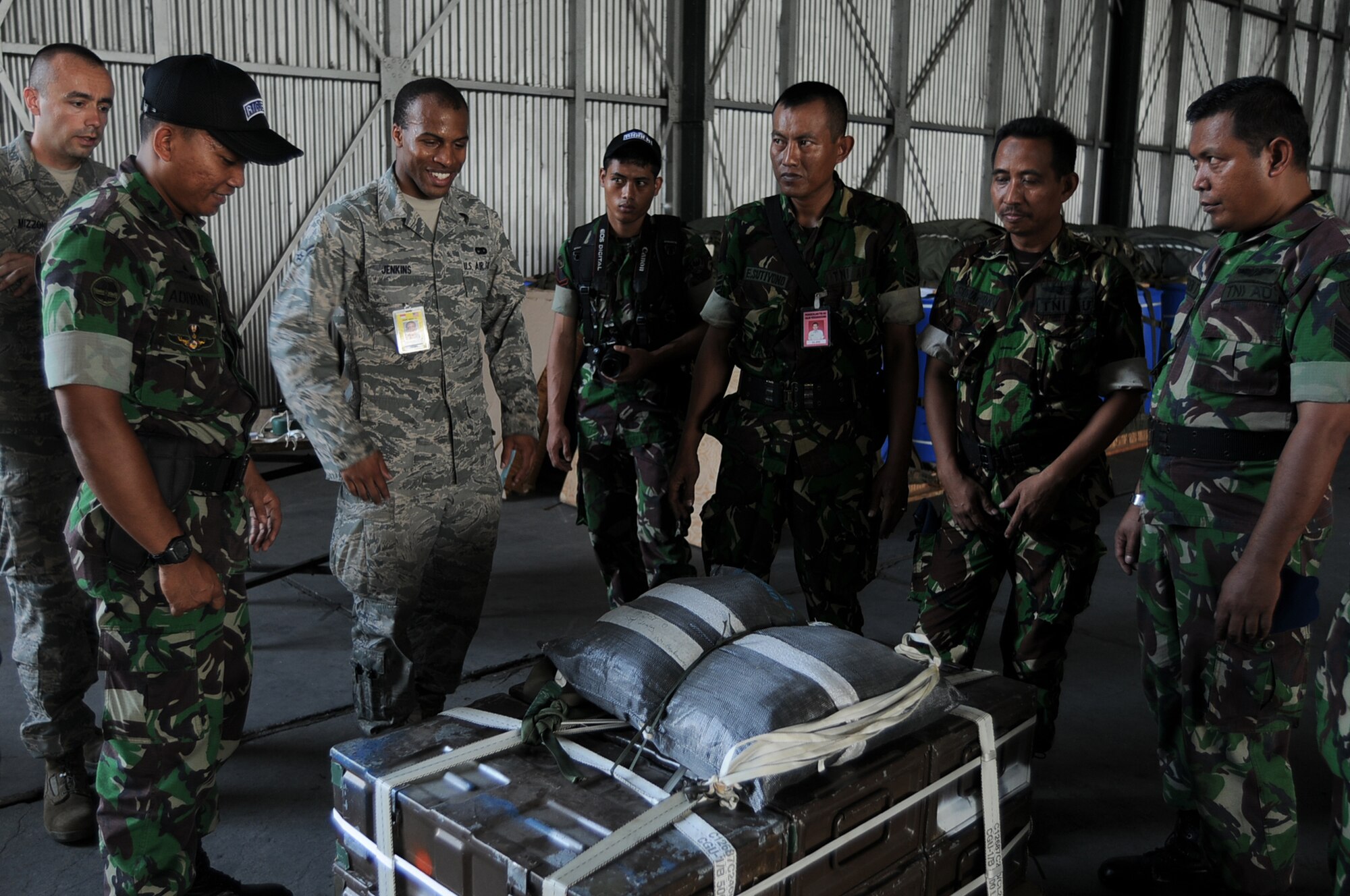 HALIM AIR BASE, Indonesia -- Airman 1st Class Brandon Jenkins, a rigger with the 374th Logistics Readiness Squadron's Combat Mobility Flight and a group of Indonesian Air Force and Army riggers admire their finished Low-Cost, Low-Altitude bundle during a rigging lesson at Exercise Cope West 11 at Halim Air Base, Indonesia, June 22, 2011. The cargo rigging lesson was entirely hands-on with U.S. and Indonesian riggers working side-by-side to build an LCLA bundle, which is a newer type of pallet commonly used by U.S. forces to airdrop supplies quickly and efficiently. (U.S. Air Force photo/Capt. Raymond Geoffroy)
