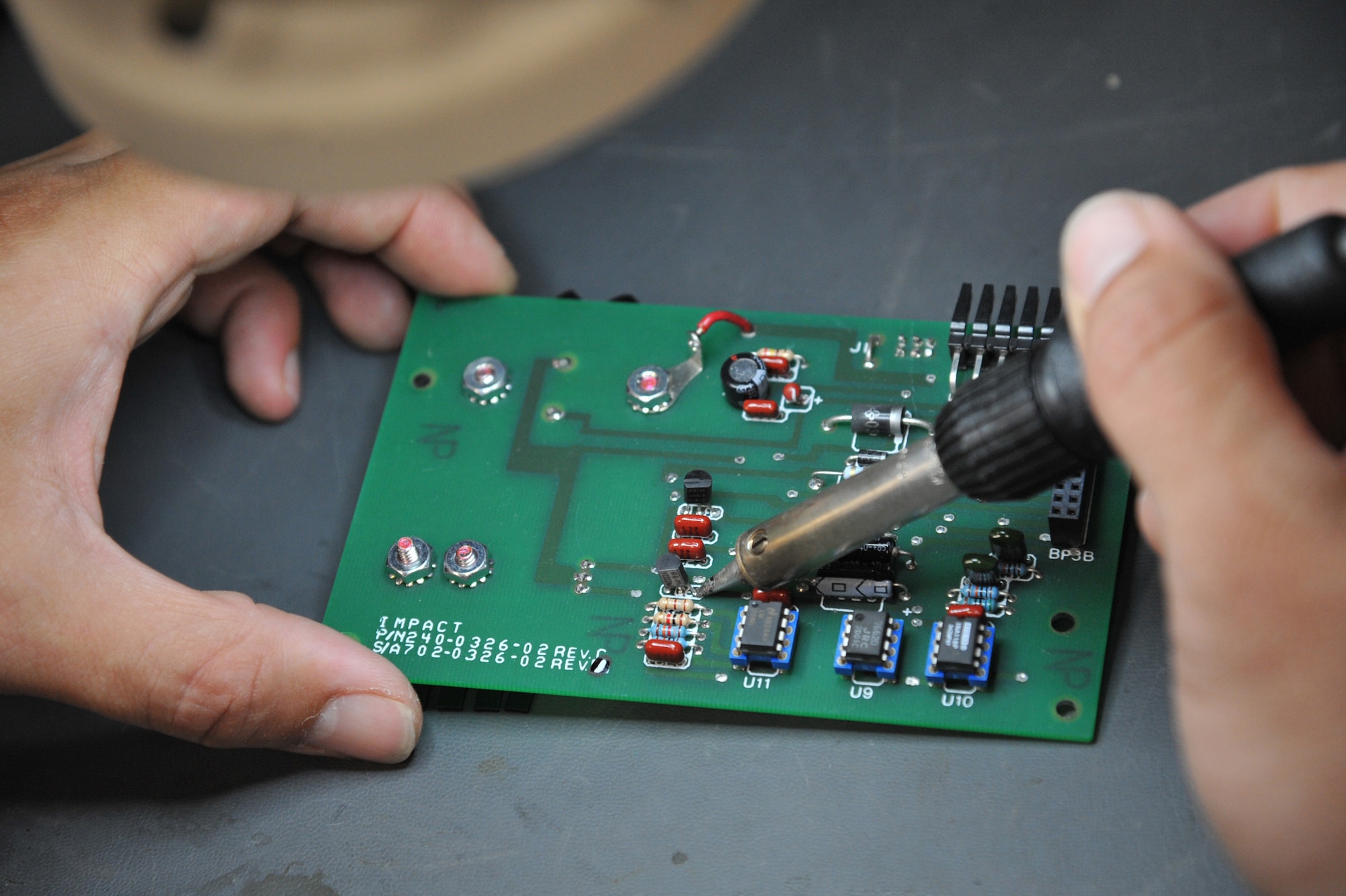 SEYMOUR JOHNSON AIR FORCE BASE, N.C.- Staff Sgt. Erik Chenault inspects a controller circuit cord assembly during a troubleshoot in the Air Force Repair Enhancement Program (AFREP) office here, June 21, 2011. To ensure all components are working properly circuit board are inspected and then repaired if needed. AFREP repair aircraft parts, XBoxs, Play Station 3s, laptops, flat screen televisions and much more. Sergeant Chenault is a 4th Maintenance Operations Squadron circuit cord repair technician and a native of Lexington, Ky. (U.S. Air Force photo by Senior Airman Whitney Lambert/ Released)