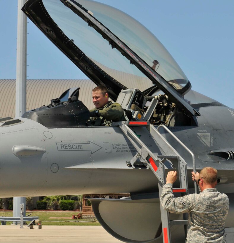 Col. John Colombo, Air Forces Northern, prepares to exit the cockpit of an F-16 one last time after his fini-flight at Tyndall Air Force Base, Fla., June 20. During his 24-year career as a fighter pilot, Colonel Colombo flew 3,570 hours. (U.S. Air Force photo by Lisa Norman) 
