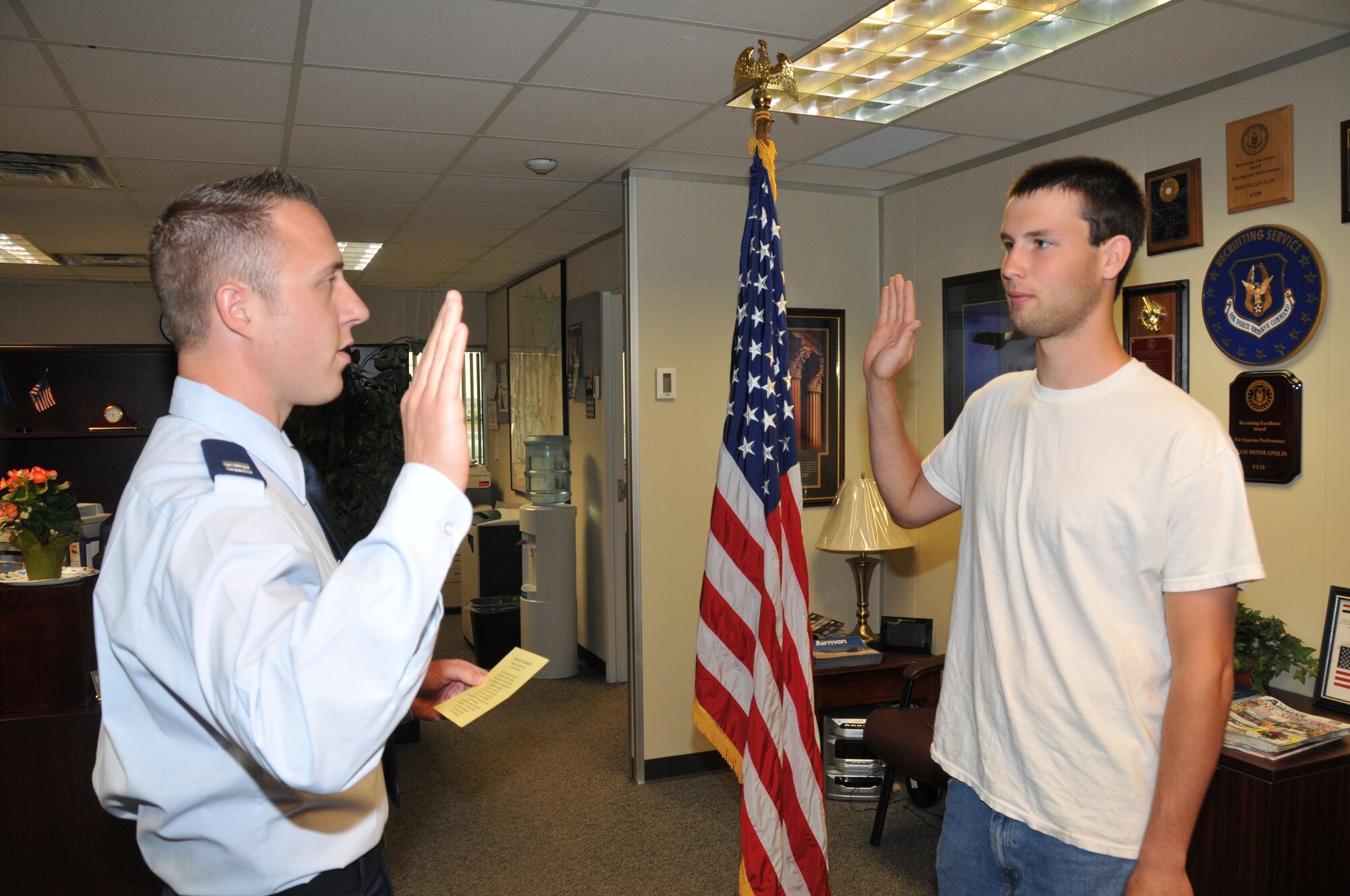 Collin Western receives the oath of enlistment from Capt. Ethan Bryant, 96th Airlift Squadron, June 20 putting the 934th Recruiters at their yearly goal three months early. Western will enter the service as an E-3 and attend technical school to become an electrician at the 934th Civil Engineer Squadron. (Air Force Photo/Paul Zadach)