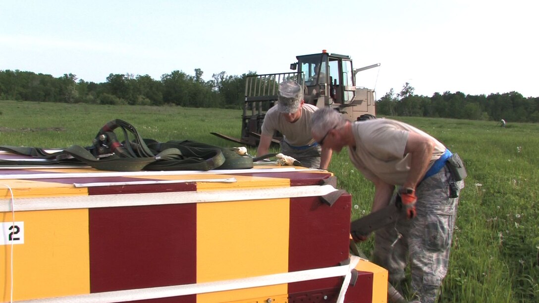 The 934th Airlift Wing conducts Inproved Container Delivery System training at the Arno Drop Zone at Camp Ripley, Minn. (Air Force Photo/Wendy Cormier) 
