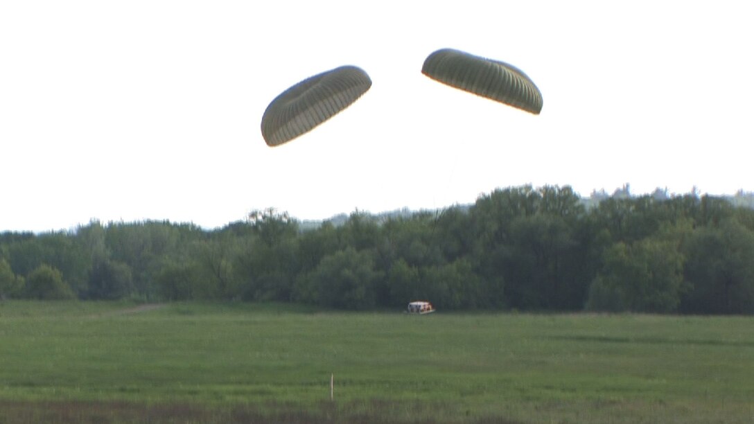 The 934th Airlift Wing conducts Inproved Container Delivery System training at the Arno Drop Zone at Camp Ripley, Minn. (Air Force Photo/Wendy Cormier) 