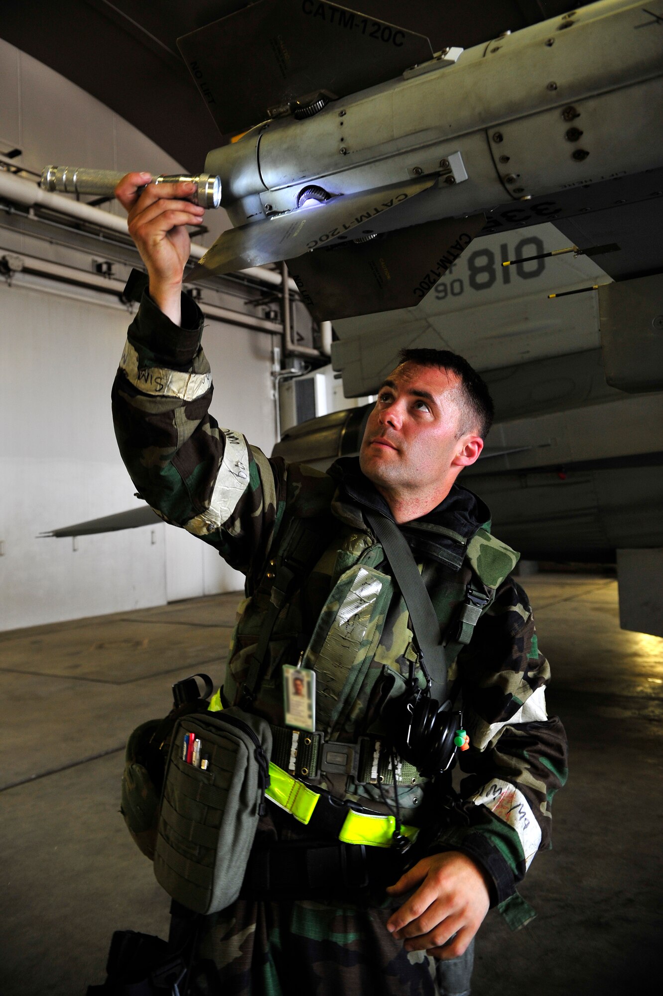 MISAWA AIR BASE, Japan -- Staff Sgt. Patrick Cannon, 14th Aircraft Maintenance Unit weapons loader, prepares an F-16 Fighting Falcon for weapons systems during an exercise, June 22. The 35th Fighter Wing is engaged in a week-long exercise, simulating a variety of scenarios in a combat environment. (U.S. Air Force photo/Staff Sgt. Nathan Lipscomb)