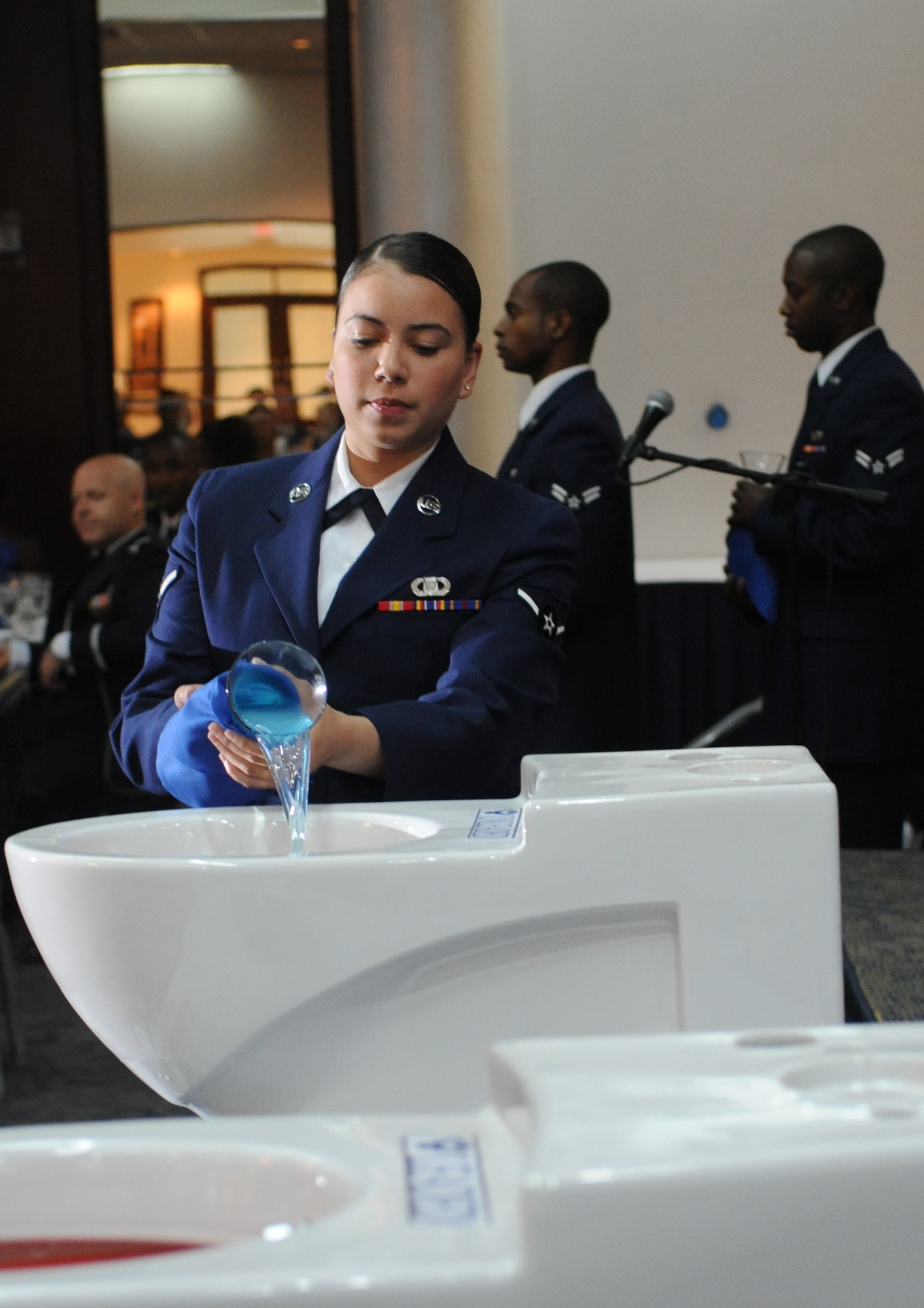 Airman Betsy Carrion, 39th Operations Squadron, mixes ingredients into the Grog, a bowl filled with assorted consumable liquids, during the 39th Air Base Wing Dining Out June 16, 2011, at the Club Complex Ballroom, Incirlik Air Base, Turkey.  (U.S. Air Force photo by Airman 1st Class Clayton Lenhardt/Released)