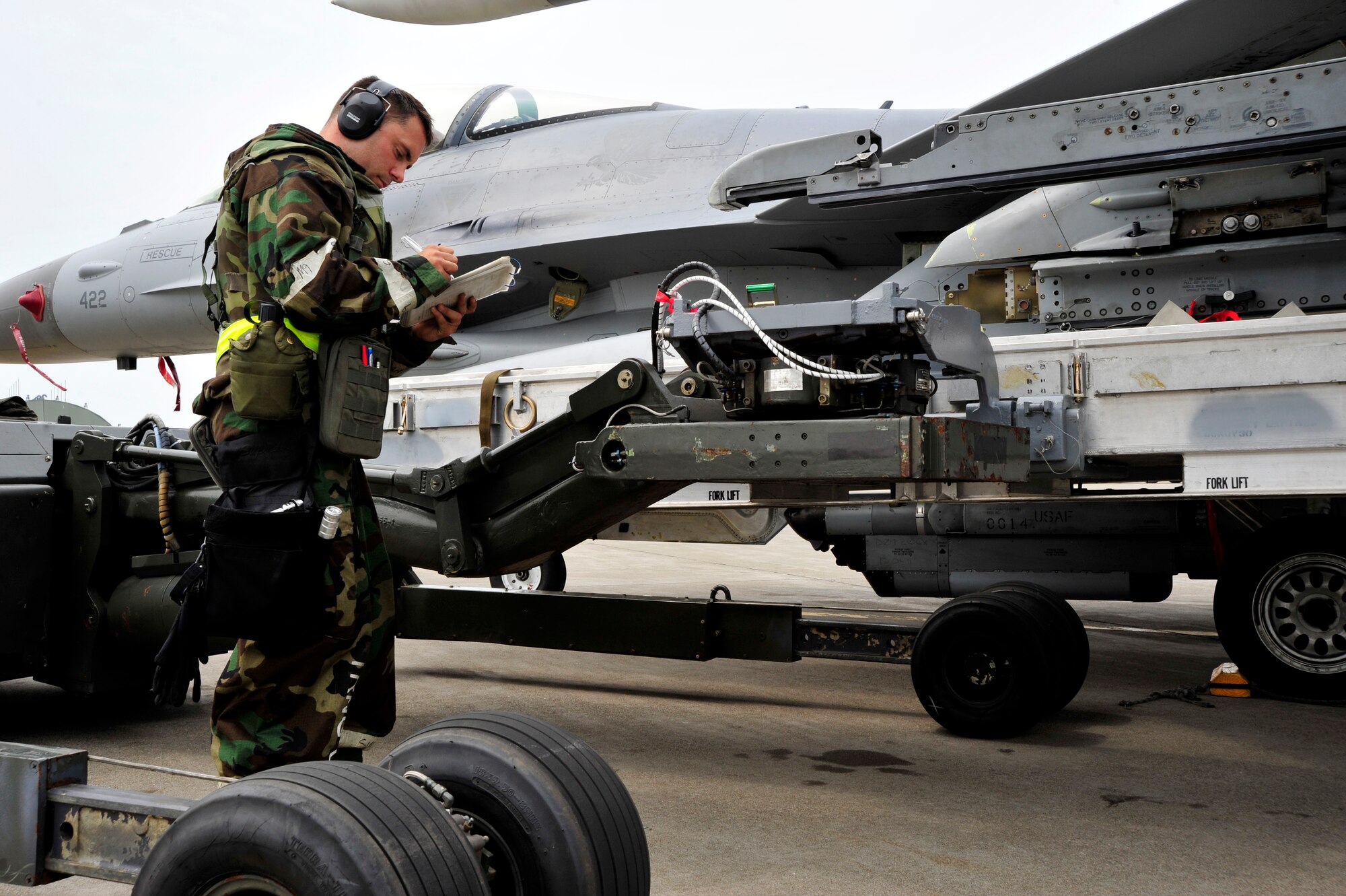 MISAWA AIR BASE, Japan -- Staff Sgt. Patrick Cannon, 14th Aircraft Maintenance Unit weapons loader, prepares an F-16 Fighting Falcon for weapons systems during an exercise, June 22. The 35th Fighter Wing is engaged in a week-long exercise, simulating a variety of scenarios in a combat environment. (U.S. Air Force photo/Staff Sgt. Nathan Lipscomb)