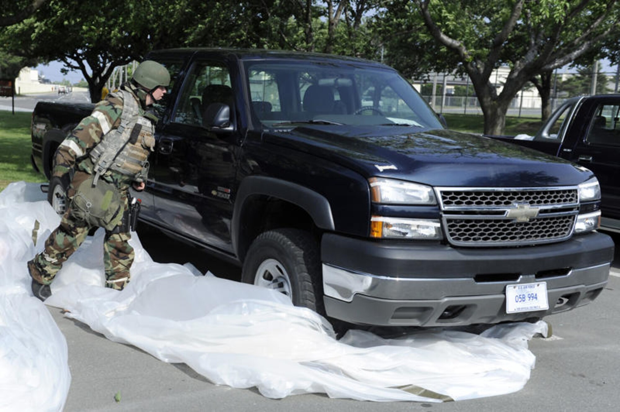 MISAWA AIR BASE, Japan -- Staff Sgt. Aaron Gatenby, 35th Security Forces Squadron, inspects vehicles during a training exercise June 22. Airmen are evaluated on their response to various injects from exercise evaluation team members. (U.S. Air Force photo/Staff Sgt. Marie Brown/RELEASED)