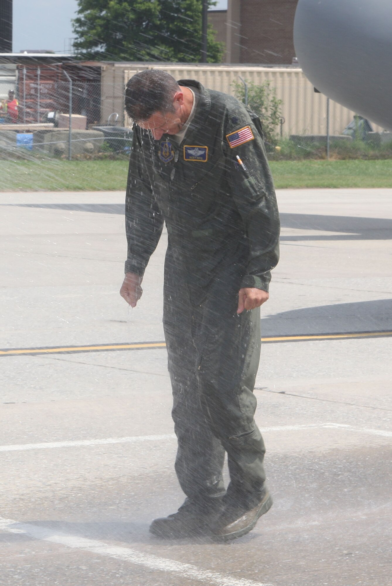 Lt. Col. Ricardo Soto receives his soaking from family during his traditional fini-flight June 20. (U.S. Air Force Photo/Don Peek)