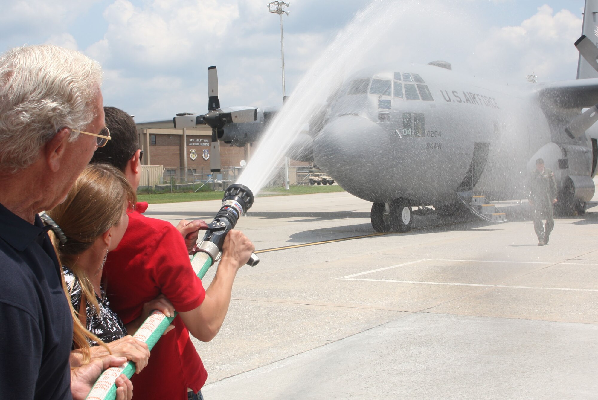 Lt. Col. Soto receives a soaking from family members. (U.S. Air Force Photo/Don Peek)