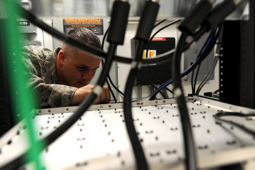 Tech. Sgt. Nathan Swab inspects a frequency tuner for corrosion at Joint Base Charleston - Weapons Station June 14. Sergeant Swab is a radio frequency transmissions craftsman with the 628th Communications Squadron. (U.S. Air Force photo/Staff Sgt.Katie Gieratz)