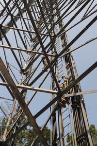 Senior Airman Matthew Baldyga and Staff Sgt. John Kinglsey climb the radio frequency tower during a training exercise at Joint Base Charleston - Weapons Station June 14. Sergeant Kingsley is a radio frequency transmissions craftsman and Airman Baldyga is a radio frequency transmissions journeyman assigned to the 628th Communications Squadron. (U.S. Air Force photo/Staff Sgt. Katie Gieratz)