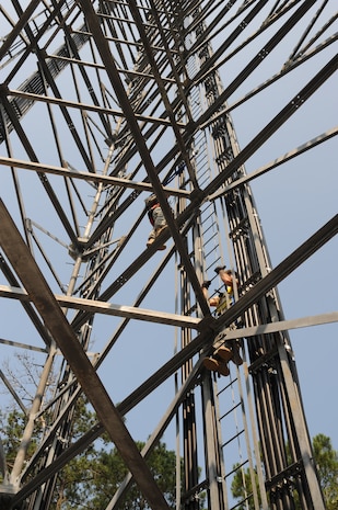 Senior Airman Matthew Baldyga and Staff Sgt. John Kinglsey climb the radio frequency tower during a training exercise at Joint Base Charleston - Weapons Station June 14. Sergeant Kingsley is a radio frequency transmissions craftsman and Airman Baldyga is a radio frequency transmissions journeyman assigned to the 628th Communications Squadron. (U.S. Air Force photo/Staff Sgt. Katie Gieratz)