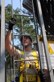 Senior Airman Matthew Baldyga prepares to climb the radio frequency tower at Joint Base Charleston -  Weapons Station June 14. Airman Baldyga is a radio frequency transmissions systems journeyman with the 628th Communications Squadron. (U.S. Air Force photo/Staff Sgt. Katie Gieratz)