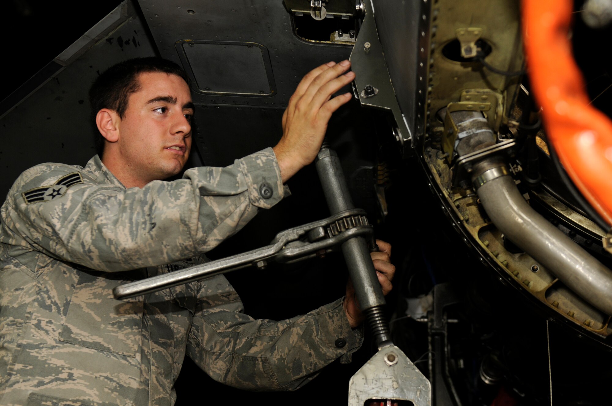 SPANGDAHLEM AIR BASE, Germany—Senior Airman Jeffrey Knight, 52nd Aircraft Maintenance Squadron crew chief, helps remove an engine here June 21. The team of maintainers removed the engine and conducted routine maintenance during a 5-day engine removal and installation training course. (U.S. Air Force photo/Airman 1st Class Brittney Frees)  