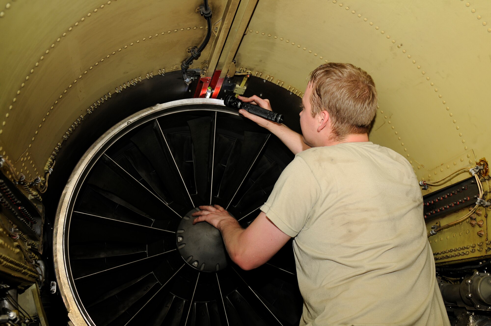 SPANGDAHLEM AIR BASE, Germany – Airman 1st Class Darrell Herringdine, 52nd Aircraft Maintenance Squadron crew chief, helps remove an engine here June 21. The team of maintainers removed the engine and conducted routine maintenance during a 5-day engine removal and installation training course. (U.S. Air Force photo/Airman 1st Class Brittney Frees)  