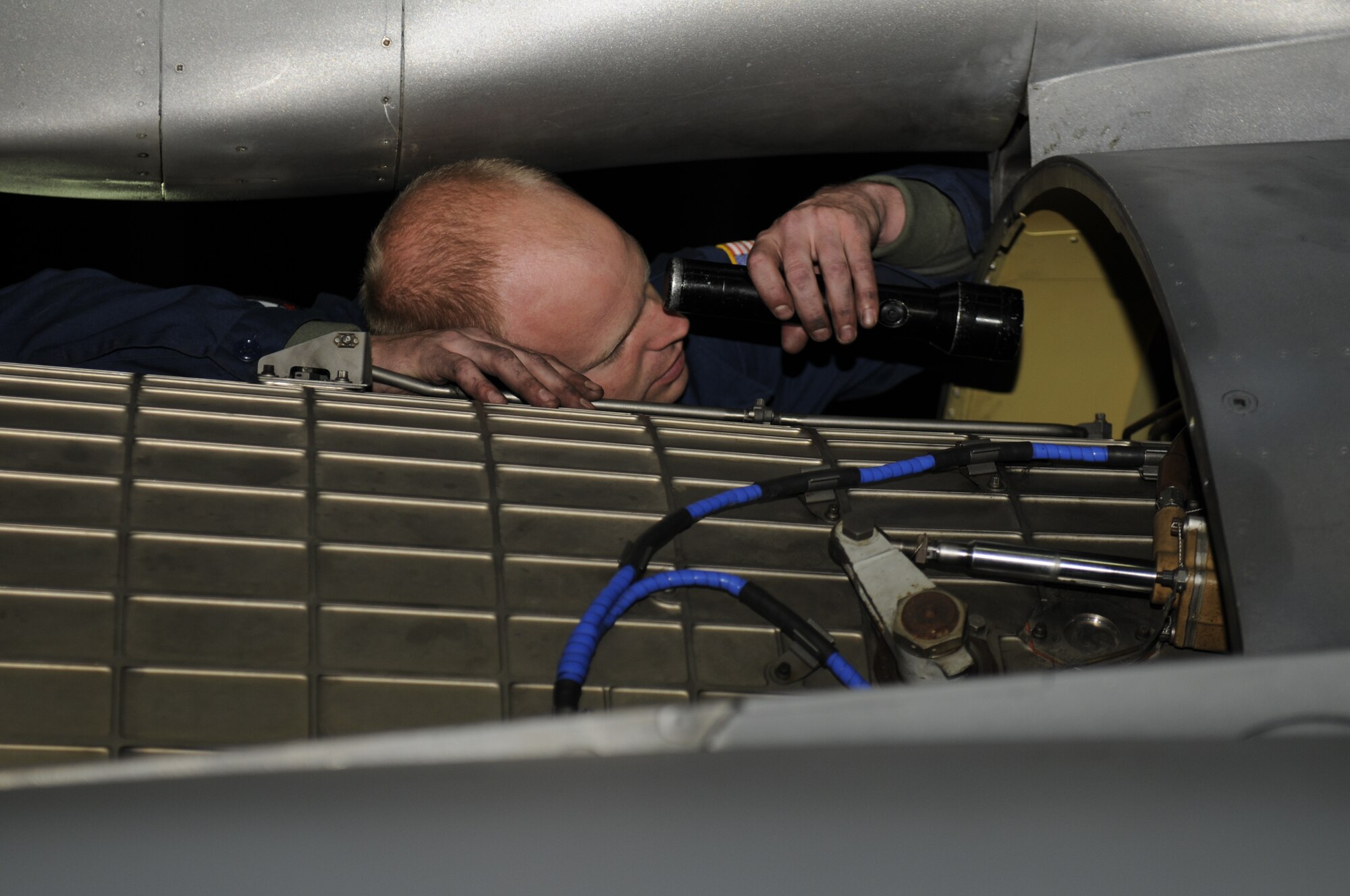 SPANGDAHLEM AIR BASE, Germany—Senior Airman Anthony Fenstra, 52nd Aircraft Maintenance Squadron crew chief, helps remove an engine here June 21. The team of maintainers removed the engine and conducted routine maintenance during a 5-day engine removal and installation training course. (U.S. Air Force photo/Airman 1st Class Brittney Frees)  
