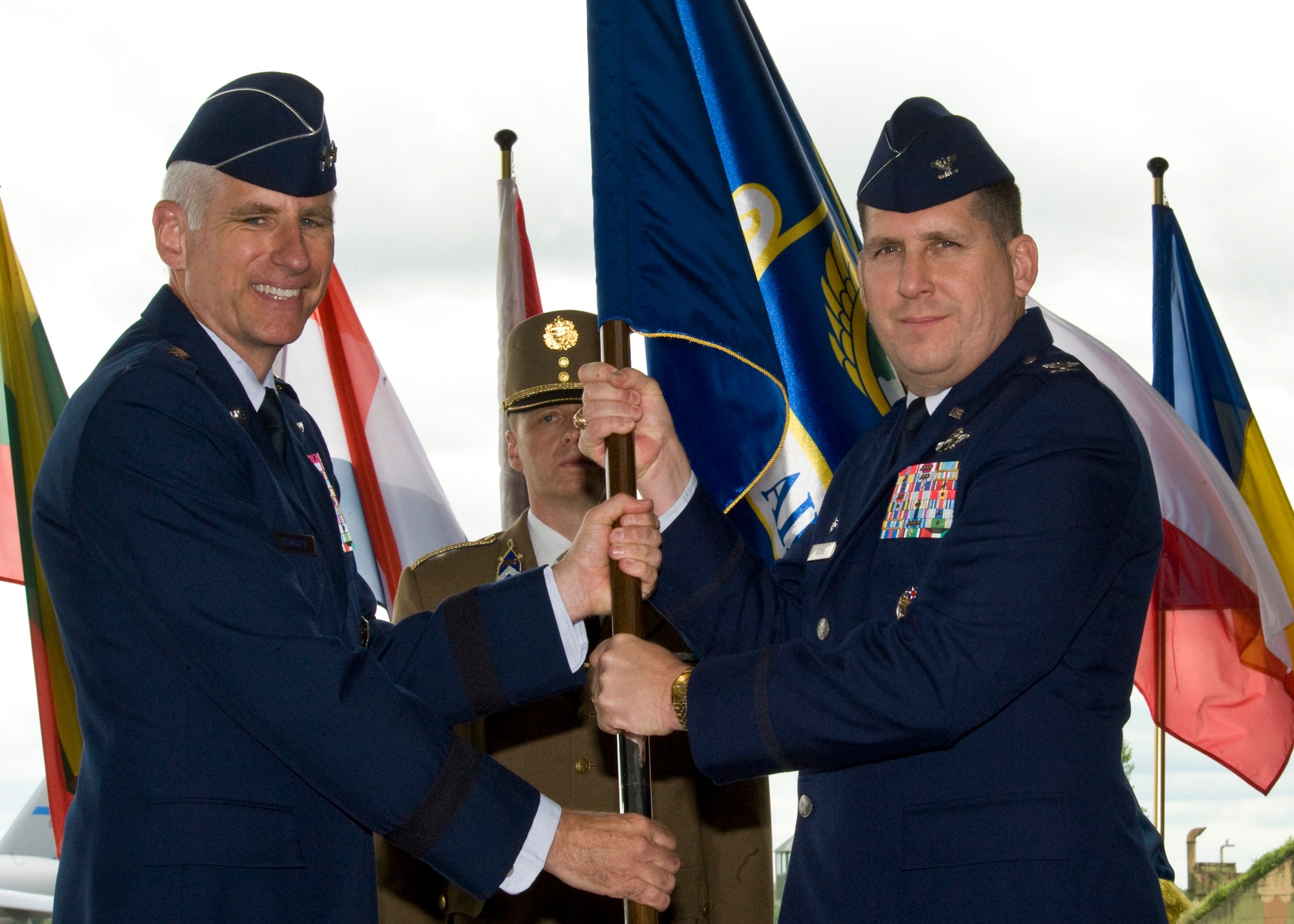 U.S. Air Force Col. Keith Boone receives the guidon from Maj. Gen. Mark Schissler, Chairman of the Strategic Airlift Capability Steering Board, during the first multinational Heavy Airlift Wing Change of Command ceremony, Papa Air Base, Hungary, June 17, 2011. (U.S. Air Force photo/TSgt Wayne Clark, AFNE Regional News Bureau) (Released)