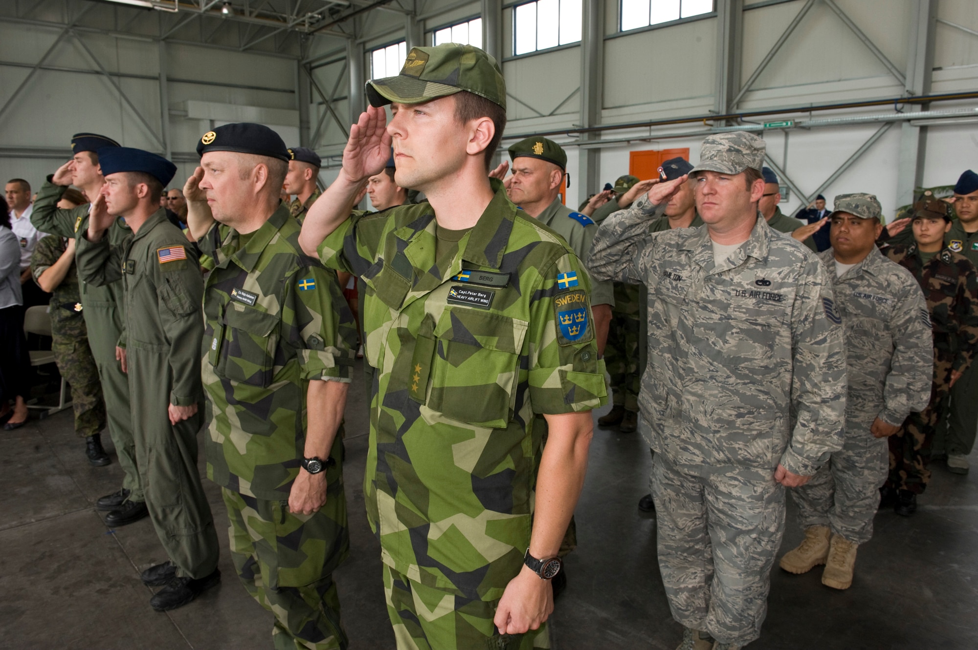 Military members of the multinational Heavy Airlift Wing (HAW) salute during the Hungarian and United States national anthem for the first Change of Command ceremony, Papa Air Base, Hungary, June 17, 2011. (U.S. Air Force photo/TSgt Wayne Clark, AFNE Regional News Bureau) (Released)
