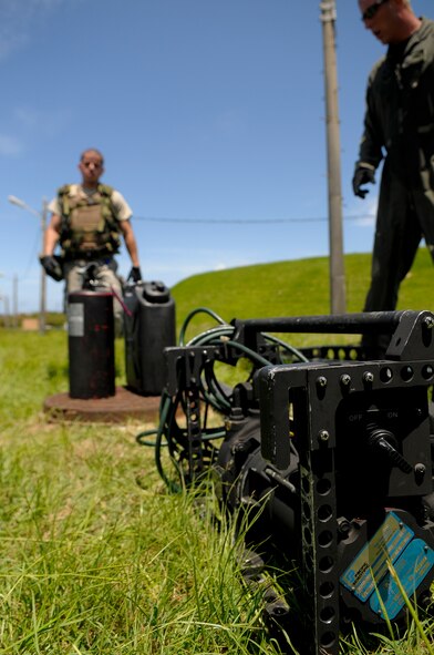 A competitor in the Forward Area Refueling Point tryouts races to retrieve a fire extinguisher and water container as part of the tryouts on Kadena Air Base, Japan, June 17. During the obstacle course portion of the tryouts, contestants were timed on their ability to perform everything from dragging the 200-pound hose 300 feet and clearing it with a squeegee, to holding the hose overhead and then performing pushups in the Okinawan heat. (U.S. Air Force photo/Airman 1st Class Maeson L. Elleman)