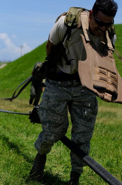 Tech. Sgt. Paiea Suganuma, 18th Logistic Readiness Squadron NCO in charge of mobile distribution and Forward Area Refueling Point tryouts competitor, squeegees a fuel hose as part of the FARP tryouts on Kadena Air Base, Japan, June 17. Though the job is easily defined as an essential wartime capability, FARP has made its presence in the world as a humanitarian aid as well, especially in support of Operation Tomodachi, where U.S. military assets greatly assisted in the relief efforts following the devastating earthquake and tsunami that struck the island of Honshu, Japan, March 11. (U.S. Air Force photo/Airman 1st Class Maeson L. Elleman)