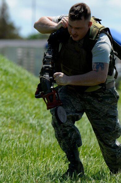 Staff Sgt. Ryan Hemenway, 18th Logistic Readiness Squadron Fuel Service Center supervisor and Forward Area Refueling Point tryouts competitor, drags a 200-pound, 300-foot fuel hose as part of the FARP tryouts on Kadena Air Base, Japan, June 17. Though only five Air Force bases in the world have a FARP program, it is an essential component for military operations for both wartime contingencies and humanitarian aid. (U.S. Air Force photo/Airman 1st Class Maeson L. Elleman)