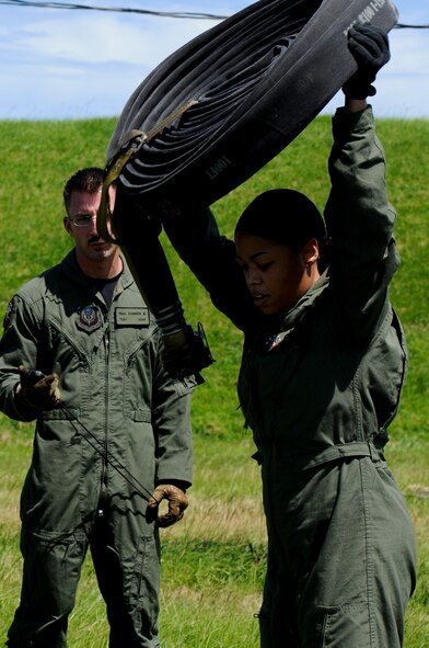 Staff Sgt. Shawnika Danielson, 18th Logistic Readiness Squadron Forward Area Refueling Point team member, lifts a 200-pound, 300-foot fuel hose over her head as part of the FARP tryouts demonstration on Kadena Air Base, Japan, June 17. Though the job is easily defined as an essential wartime capability, FARP has made its presence in the world as a humanitarian aid as well, especially in support of Operation Tomodachi, where U.S. military assets greatly assisted in the relief efforts following the devastating earthquake and tsunami that struck the island of Honshu, Japan, March 11. (U.S. Air Force photo/Airman 1st Class Maeson L. Elleman)