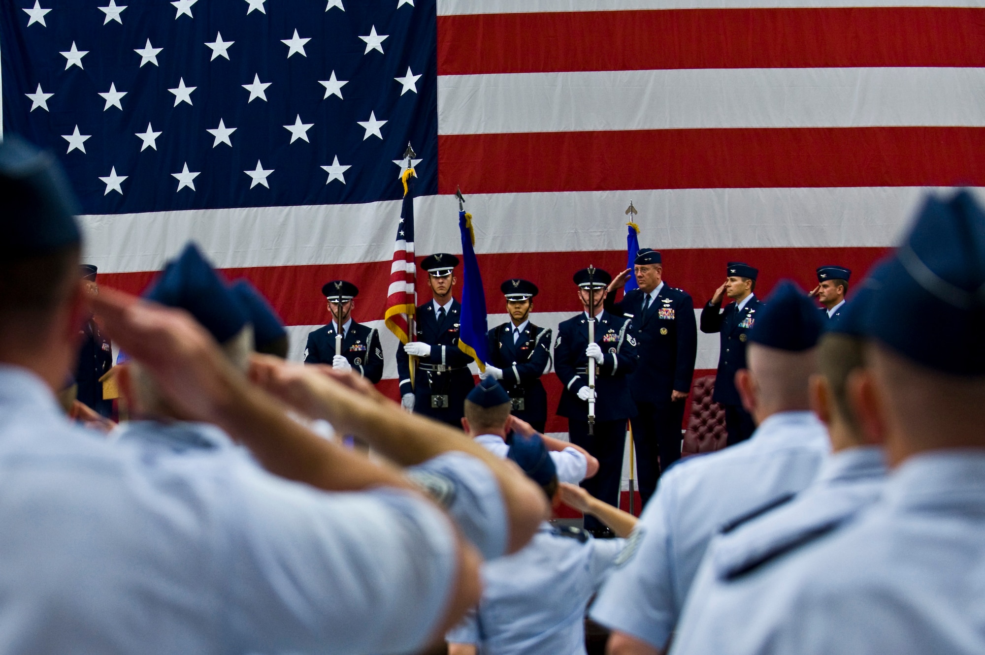 Nellis Air Force Base Honor Guard members post the colors during a ceremony re-designating the 98th Range Wing as The Nevada Test and Training Range at Nellis Air Force Base, Nev., June 21, 2011. Col. Kenneth Thompson, former defense and air attaché to the U.S. Embassy in Cairo, assumed command of the NTTR during the event. Like the 98 RANW, The NTTR will remain a direct reporting unit to the U.S. Air Force Warfare Center and continue to operate, maintain and manage the 2.9-million-acre range (42 percent of the land managed by the U.S. Air Force) and 12,000 square miles of military airspace. More than 1,000 military, civilian and contract personnel are assigned to the organization. (U.S. Air Force photo by Senior Airman Brett Clashman/Released)