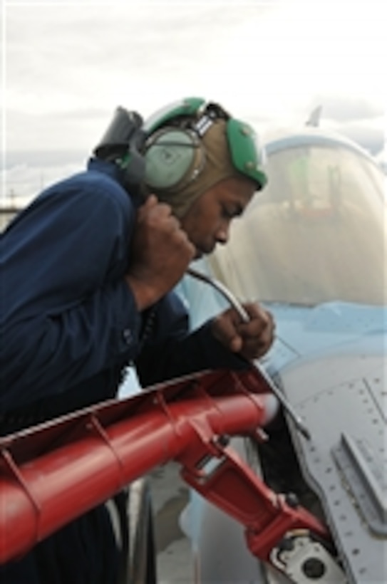 U.S. Navy Petty Officer 3rd Class Yusuf Martin, assigned to Fighter Squadron Composite 12, completes maintenance on the in-flight refueling probe of an F/A-18C Hornet aircraft during Exercise Northern Edge in Anchorage, Alaska, on June 14, 2011.  Northern Edge is an annual joint training exercise designed to test military and civilian response and coordination capabilities while enhancing the command, control and communications relationships associated with joint operations.  