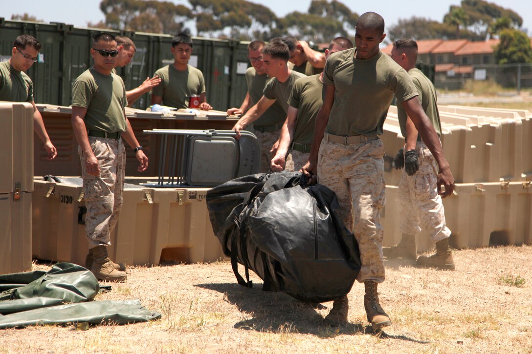 Marines and sailors with the 15th Marine Expeditionary Unit (MEU) set up tents for a command operations center. The unit set up the tents for a Command Post Exercise (CPEX) here at Camp Del Mar, June 20-23.