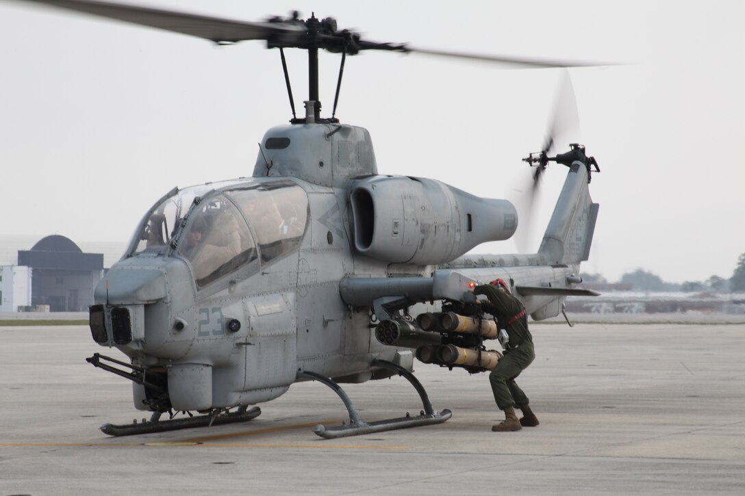 Lance Cpl. Carl L. Swanguarim, an ordnance technician, checks the weapon racks aboard an AH-1W Super Cobra prior to a mission by Marine Light Attack Helicopter Squadron 467 helicopters aboard Marine Corps Air Station Cherry Point, N.C., June 23. This mission was possibly the last firing of tube launched, optically tracked, wire guided missiles by HMLA-467.