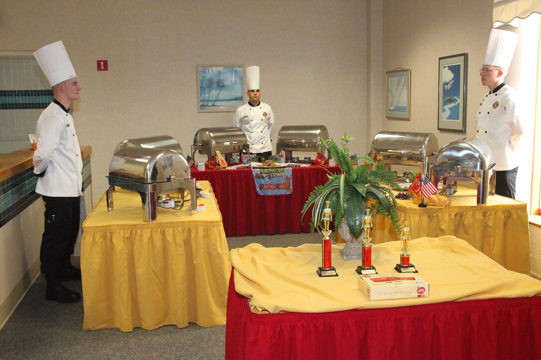 The chef of the quarter competitors wait for their meals to be served to Marines and Sailors who attended the competition at the mess hall June 23. Competitors were judged on their preparation, presentation and overall taste of their food.