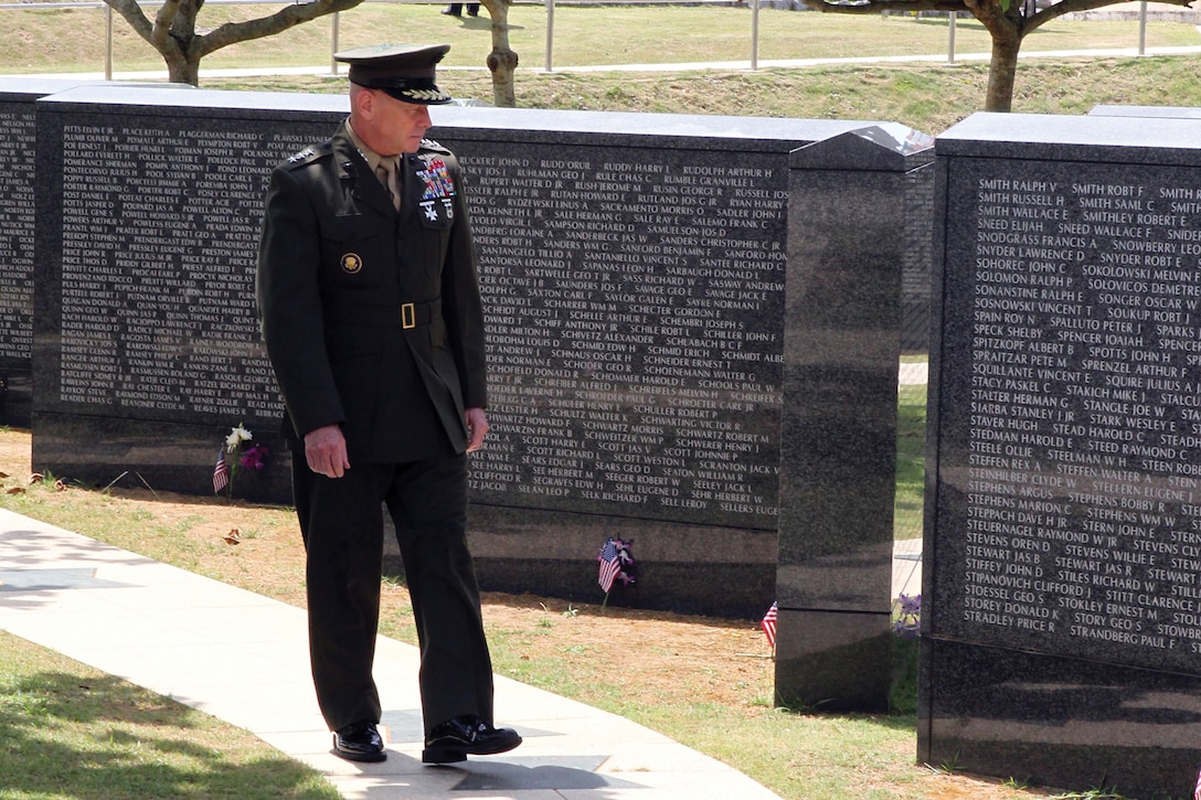 Lt. Gen. Kenneth J. Glueck Jr., commanding general of III Marine Expeditionary Force and commander of Marine Corps Bases Japan, looks at names on the Cornerstone of Peace at Okinawa Peace Memorial Park in Itoman City, during the 2011 Okinawa Memorial Service for All War Dead June 23.