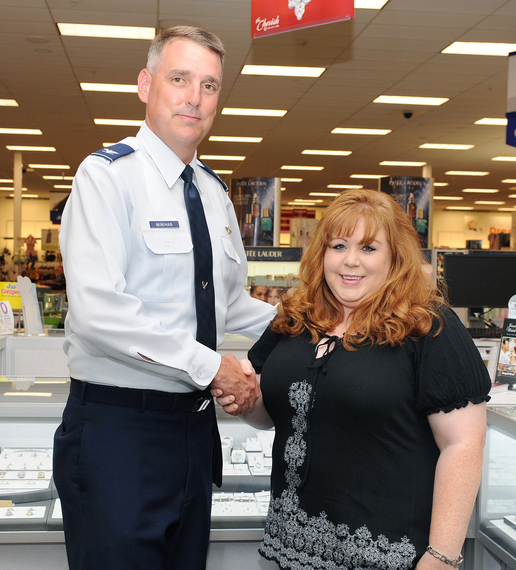 Col. Mike Minihan, 19th Airlift Wing commander, presents his commander’s coin to Shannon Koder, an Army and Air Force Exchange Service operations manager, for her selection as the Combat Airlifter of the Week on June 20, 2011, at Little Rock Air Force Base, Ark. Ms. Koder has been the operations manager of the base exchange for one year. (U.S. Air Force photo / Airman 1st Class Ellora Remington)