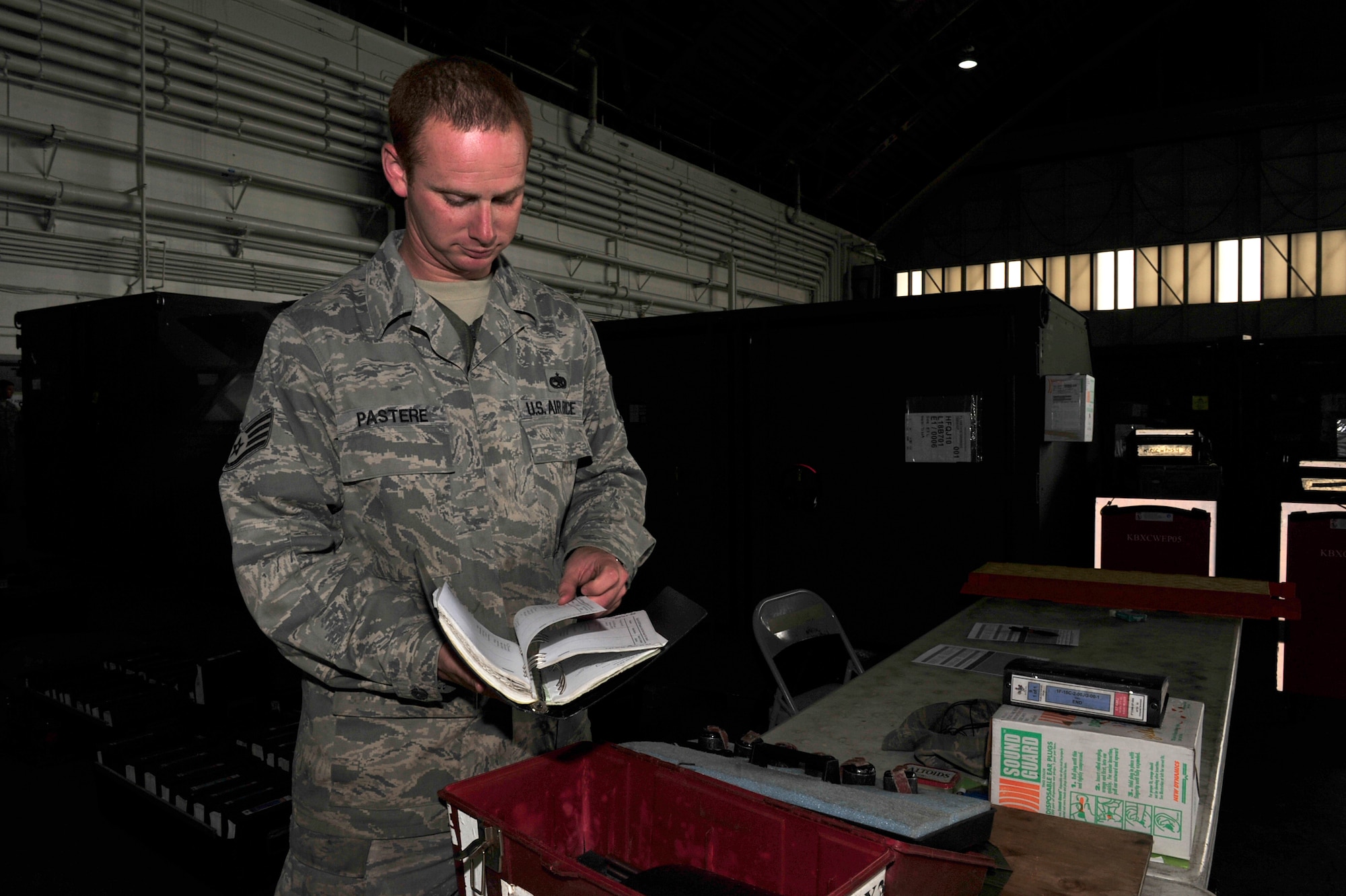U.S. Air Force Staff Sgt. George Pastere, a crew chief with the 18th Aircraft Maintenance Squadron, Kadena Air Base, Japan, inspects technical orders during the Northern Edge Premier Training Exercise at Eielson Air Force Base, Alaska, June 23.  Sergeant Pastere was notified June 23 that he was selected for promotion to technical sergeant.  (U.S. Air Force photo/ Staff Sgt. Lakisha A. Croley)