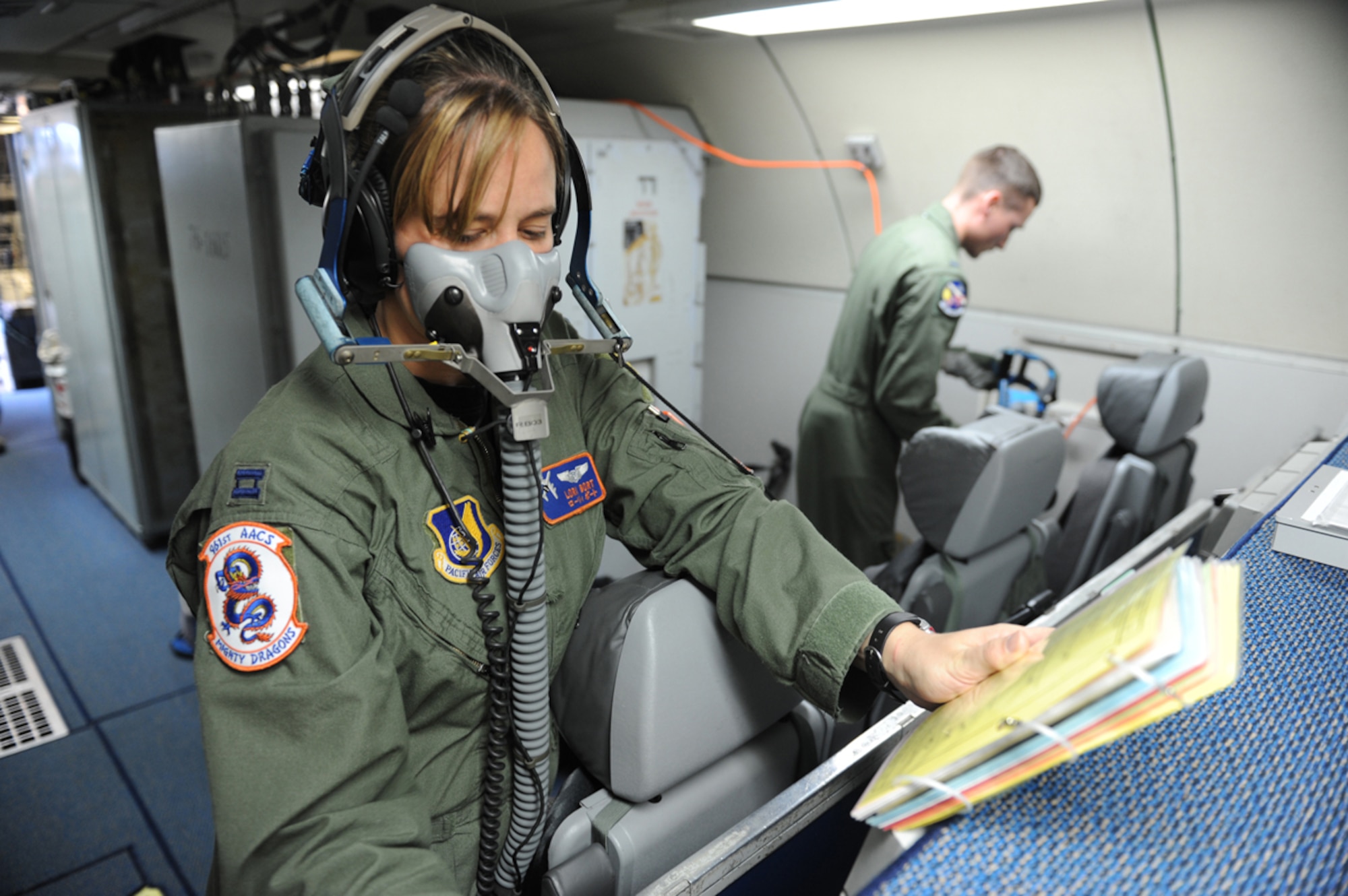 JOINT BASE ELMENDORF- RICHARDSON, Alaska -- Air Force Capt. Lori Bort, E-3 Sentry Airborne Warning and Control System air surveillance officer, performs pre-flight checks before a training mission during Exercise Northern Edge 11 in JBER, Alaska, June 22, 2011. Northern Edge, Alaska's largest military training exercise, is designed to prepare joint forces to respond to crises throughout the Asia-Pacific region. (U.S. Navy photo/Mass Communication Specialist 2nd Class Rufus Hucks)